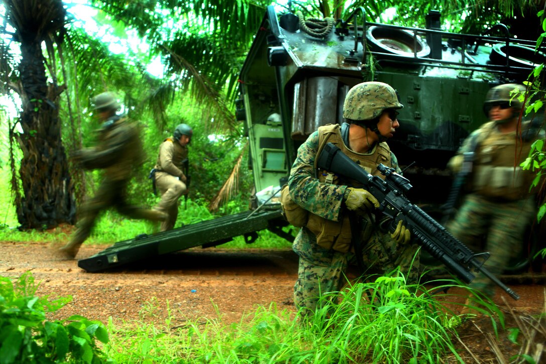Marines with Landing Force Company exit an amphibious assault vehicle May 18 during the final training exercise in Thailand for Cooperation Afloat Readiness and Training (CARAT) 2011. The FTX is an amphibious assault exercise that demonstrates interoperability between U.S. and Royal Thai Marines and Sailors. The majority of the Marines of the landing force are reservists with 2nd Battalion, 23rd Marine Regiment, 4th Marine Division and 4th Assault Amphibian Battalion. Reserve Marines are an integral element of the Marine Corps total force and share the expeditionary mindset that encompasses Marine culture. (U.S. Marine Corps Photo by Cpl. Aaron Hostutler)