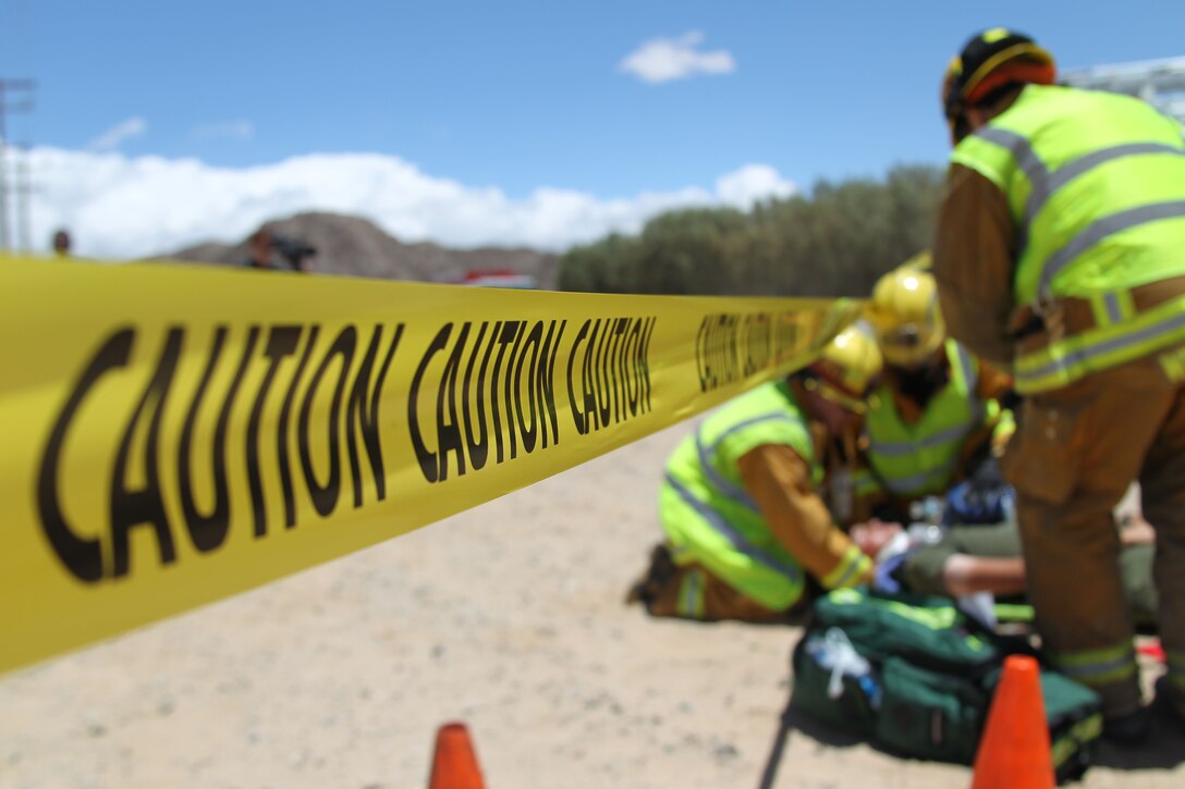 Yellow caution tape marks the perimeter of a simulated vehicle accident scene on Adobe Road May 18, 2011. The mock accident between a 7-ton truck and van was part of the state-wide exercise Golden Guardian, which evaluated the Combat Center’s response to natural disasters.