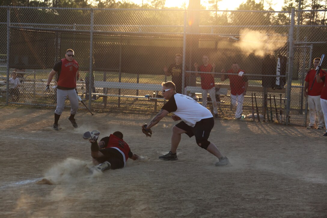 Corey L. Homa tags the runner Shane E. Santarsiero out at home during the 2011 Cherry Point Intramural Softball Championship Game May 18. Homa and the rest of the Avi Silverbacks celebrated a bottom of the seventh walk-off win to finish the game 11-10 against Can Do Easy. Homa is the catcher for the Avi Silverbacks; Santarsiero is the second baseman for Can Do Easy.