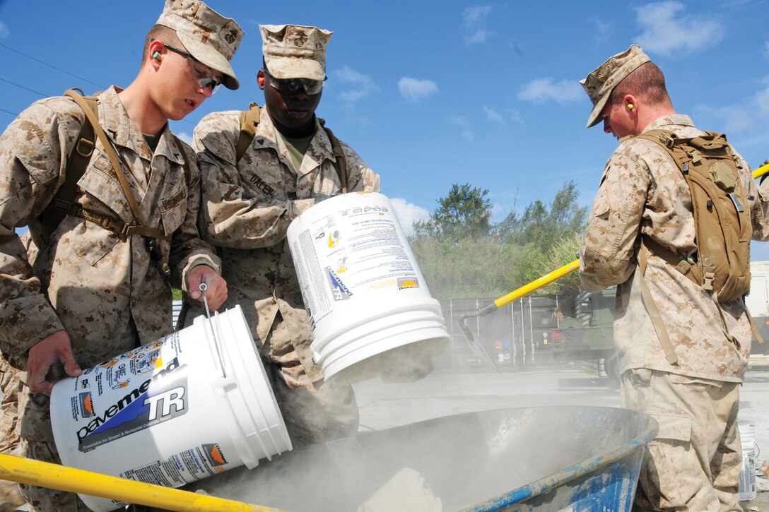 Marines from Marine Wing Support Squadron 172 pour concrete mix during a week-long rapid runway repair course at Kadena Air Base’s Silver Flag site.