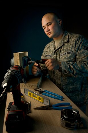 NELLIS AIR FORCE BASE, Nev.-- Senior Airman Jonathan Colom-Ortiz, a safe technician journeyman from the 99th Civil Engineering Squadron, works on a Kaba Mos X-09 High Security lock May 18.  The lock is used for top secret areas, vaults, and safes. Airman Colom-Ortiz is one of few stationed at Nellis that is certified to work on this type of lock. "The best part of my job is when I'm able to fabricate and design a lock system and being able to say I made that." said Airman Colom-Ortiz. (U.S Air Force illustrative photo by Senior Airman Stephanie Rubi) 