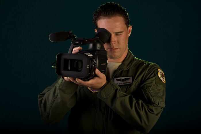 NELLIS AIR FORCE BASE, Nev. -- Staff Sgt. Jose A. Rodriguez Jr., an aerial videographer from the 99th Air Base Wing Public Affairs, provides broadcast news stories and video documentation of aerial tactics and training to include real world missions at home station and deployed. Staff Sgt. Rodriguez has been in the Air Force for 7 years. (U.S. Air Force illustrative photo by Airman 1st Class Daniel Hughes)