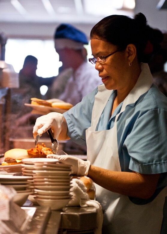 Sonja Daughtry, 919th Force Support Squadron, serves up some chicken wings on the snack line during the May unit training assembly at Duke Field.  Recently, the 919th FSS dining facility picked up its sixth John L. Hennessy award since 2000.  (U.S. Air Force photo/Tech. Sgt. Samuel King Jr.)