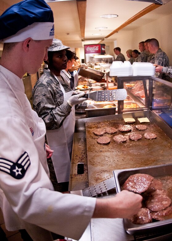 Senior Airmen Michael White and  Ashlei Jackson, 919th Force Support Squadron, take orders and cook up burgers on the snack line during the May unit training assembly at Duke Field.  Recently, the 919th FSS dining facility picked up its sixth John L. Hennessy award since 2000.  (U.S. Air Force photo/Tech. Sgt. Samuel King Jr.)