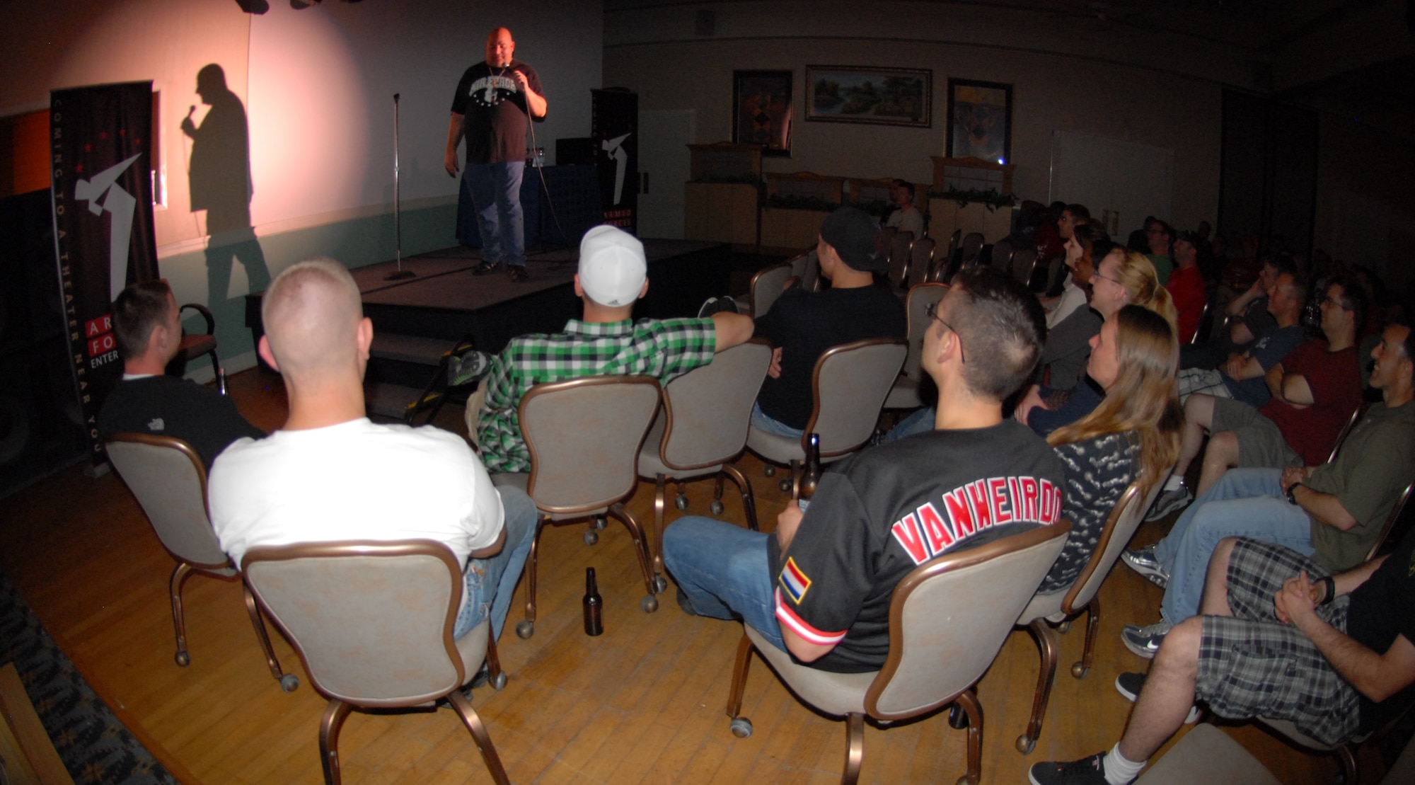 KUNSAN AIR BASE, Republic of Korea -- Wolf Pack Airmen listen and laugh as Comedian Scott Kennedy takes the stage at the Loring Club here May 18. Mr. Kennedy, a veteran comic with more than 20 years of stand-up experience, has traveled to Iraq 43 times and nearly a dozen trips to Afghanistan to entertain service members in combat zones. The comedy show is hosted by Armed Forces Entertainment, which has more than 1,200 shows around the world each year, reaching in excess of 500,000 personnel at 270 military installations. (U.S. Air Force photo/Master Sgt. Sonny Cohrs)