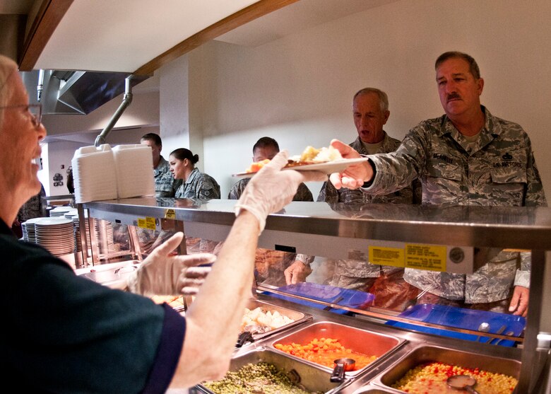 Faith Clark, 919th Force Support Squadron, hands over a plate to Senior Master Sgt. McAnnelly, 919th Maintenance Group, during the May unit training assembly at Duke Field.  Recently, the 919th FSS dining facility picked up its sixth John L. Hennessy award since 2000.  (U.S. Air Force photo/Tech. Sgt. Samuel King Jr.)