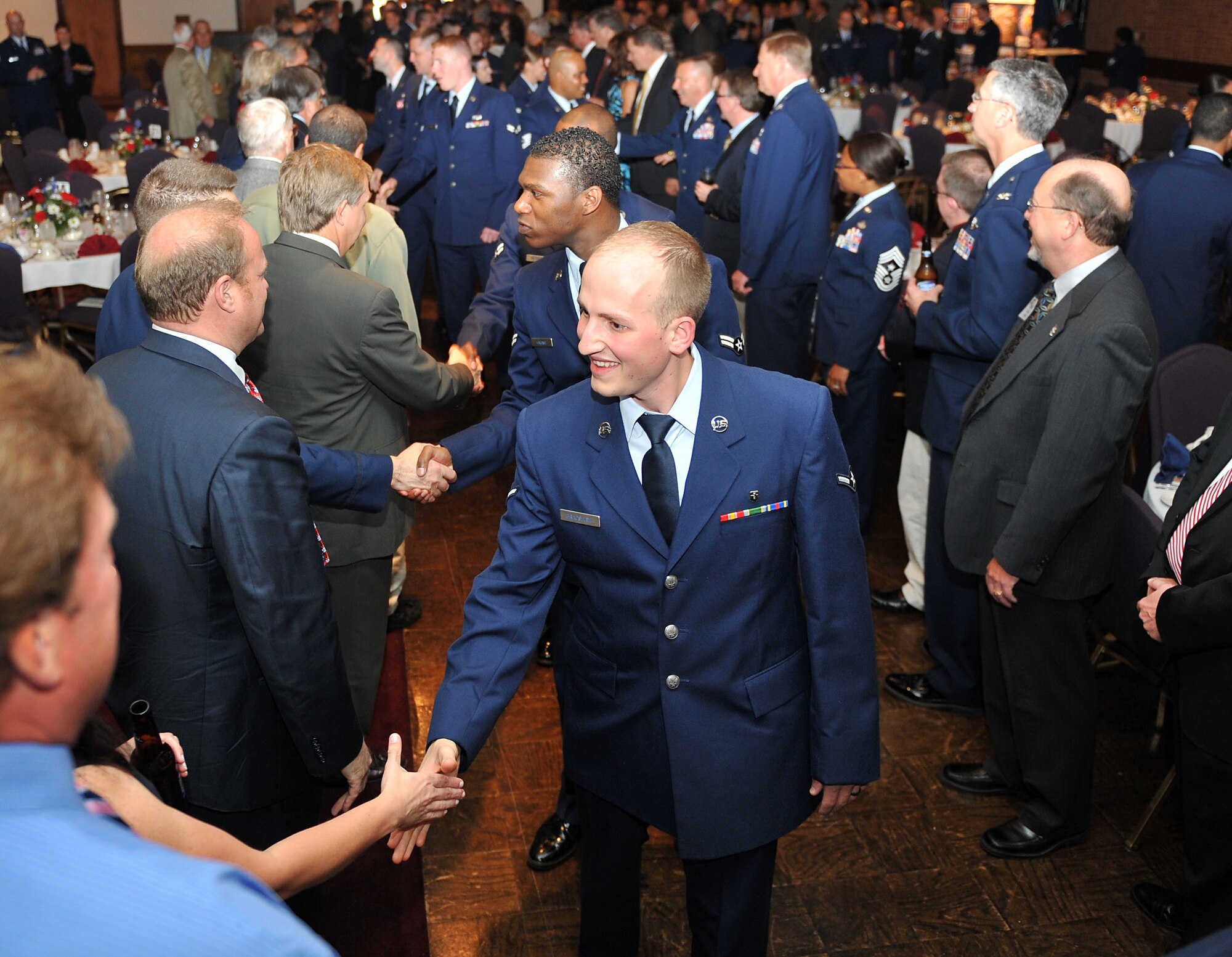 Members of Team Scott are greeted by Mark Eckert, City of Belleville Mayor, and members of the Belle-Scott committee at Fischer's Restaurant in Belleville, Ill., May 12, 2011.  The Belle-Scott Dinner was held in honor of the men and women of Scott Air Force Base for their dedication to the nation. (U.S. Air Force photo/ Airman 1st Class Divine Cox)