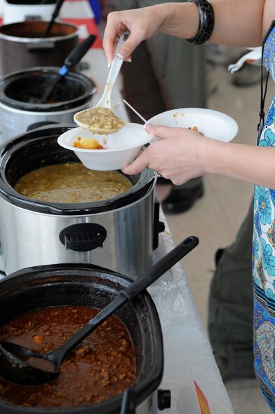 A Barksdale Air Force Base civilian samples some chili during the Eighth Air Force Chilli Cookoff at the Cyber Innovation Center in Bossier City, La., May 18. The 8 AF has a chilli cookoff every quarter and awards a prize for first, second and third best-tasting chilli, which are voted on by each member. The winner for the best-tasting chilli this quarter was Staff Sgt. Thomas Anderson, 608th Strategic Operations Squadron. (U.S. Air Force photo/Staff Sgt. John Gordinier)(RELEASED)
