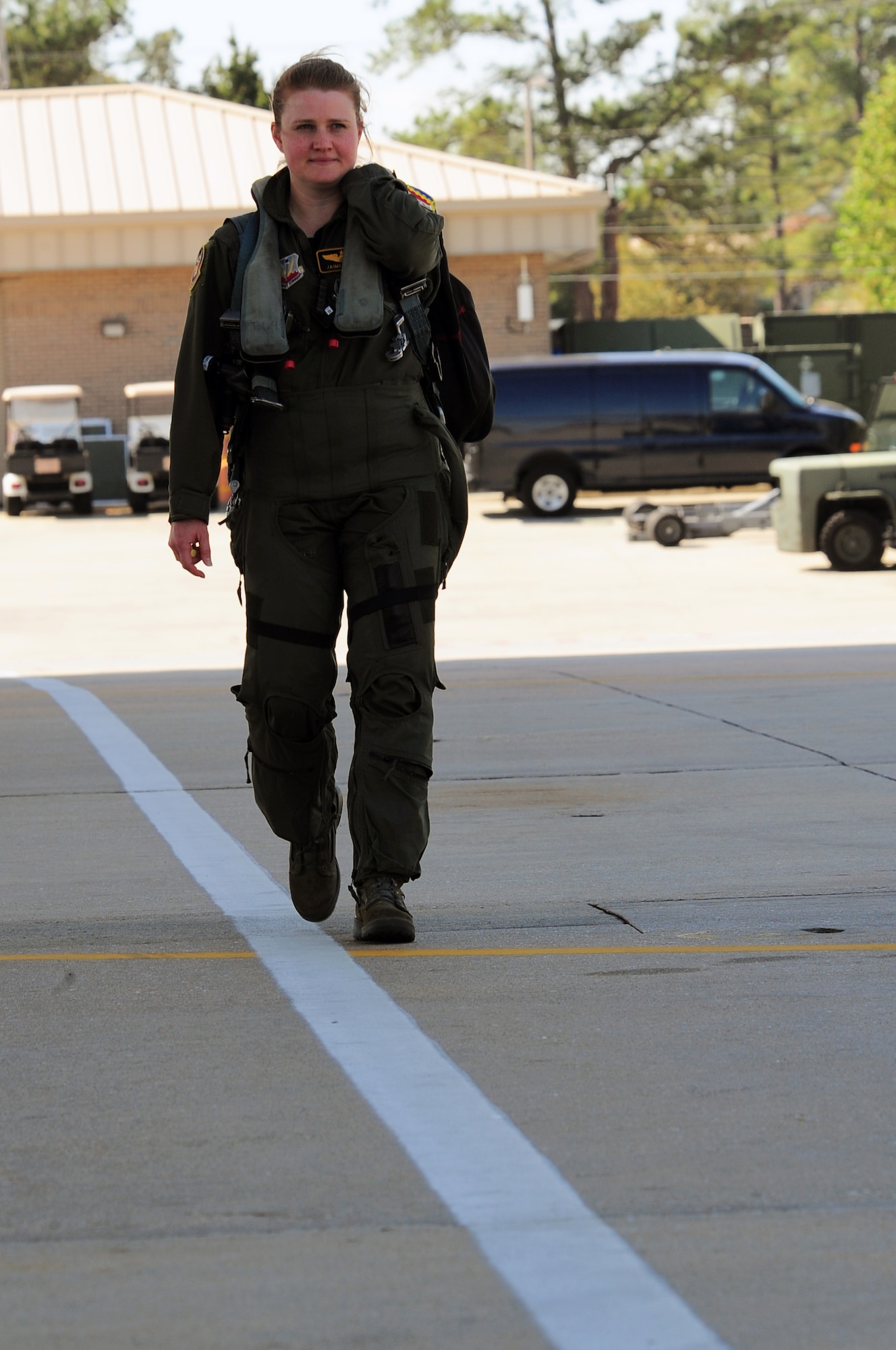 Maj. Jaime Nordin, an F-16 Fighting Falcon pilot in the 79th Fighter Squadron at Shaw Air Force Base, S.C., walks down the flight line to her plane March 26, 2011. The Air Force has had women in fighter pilot roles since 1993.(U.S. Air Force photo/Airman 1st Class Daniel Phelps)