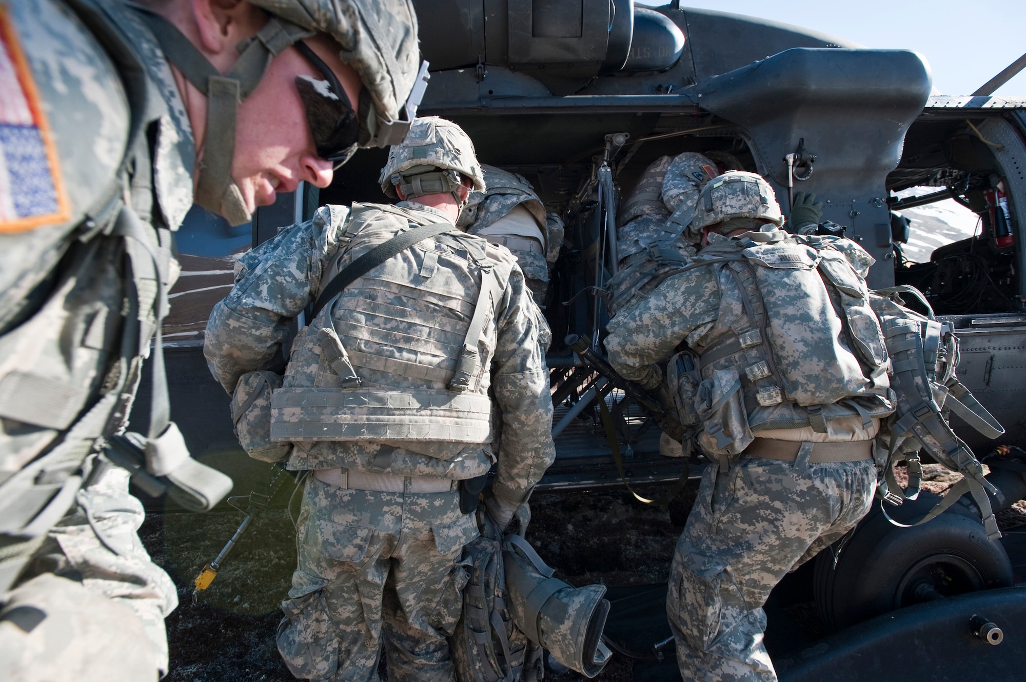 JOINT BASE ELMENDORF-RICHARDSON, Alaska -- Soldiers of Comanche Company, 1st Battalion, 501st Infantry Regiment (Airborne), get into an UH-60 Black Hawk Helicopter after finishing an air assault in Alaska's Chugach Range May 12. The Soldiers took part in the air assault training where the Black Hawks took them into a section of the mountain range and they were tasked with engaging an opposing force. (U.S. Air Force photo/Senior Airman Christopher Gross)