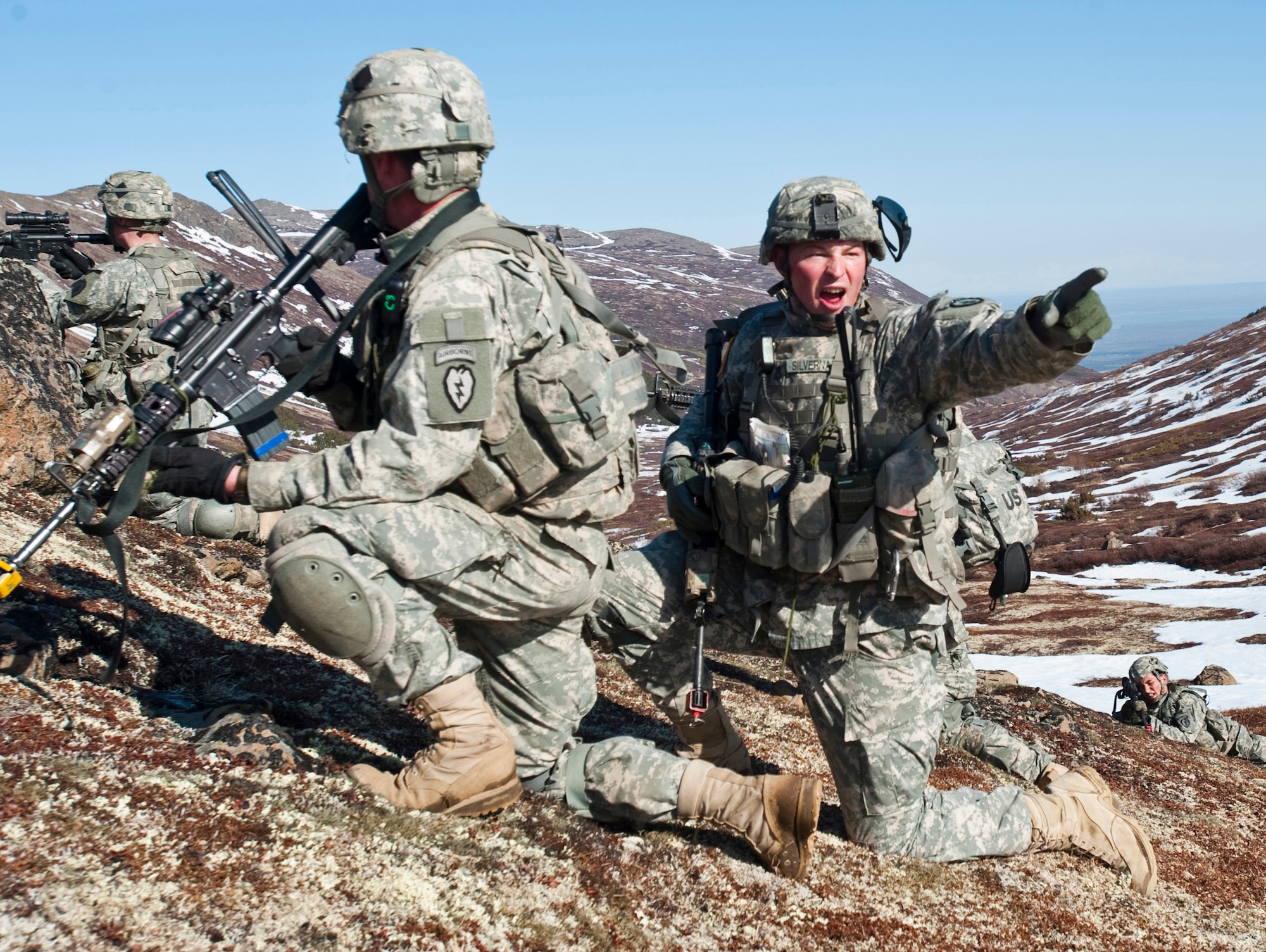 JOINT BASE ELMENDORF-RICHARDSON, Alaska -- Sgt. 1st Class Kyle Silvernale, platoon sergeant of the Comanche Company, 1st Battalion, 501st Infantry Regiment (Airborne), yells out commands to his troops while on an air assault training mission May 12. The Soldiers took part in the air assault training where UH-60 Black Hawk helicopters took them into a section of Alaska's Chugach Range and they were tasked with engaging an opposing force. (U.S. Air Force photo/Senior Airman Christopher Gross)