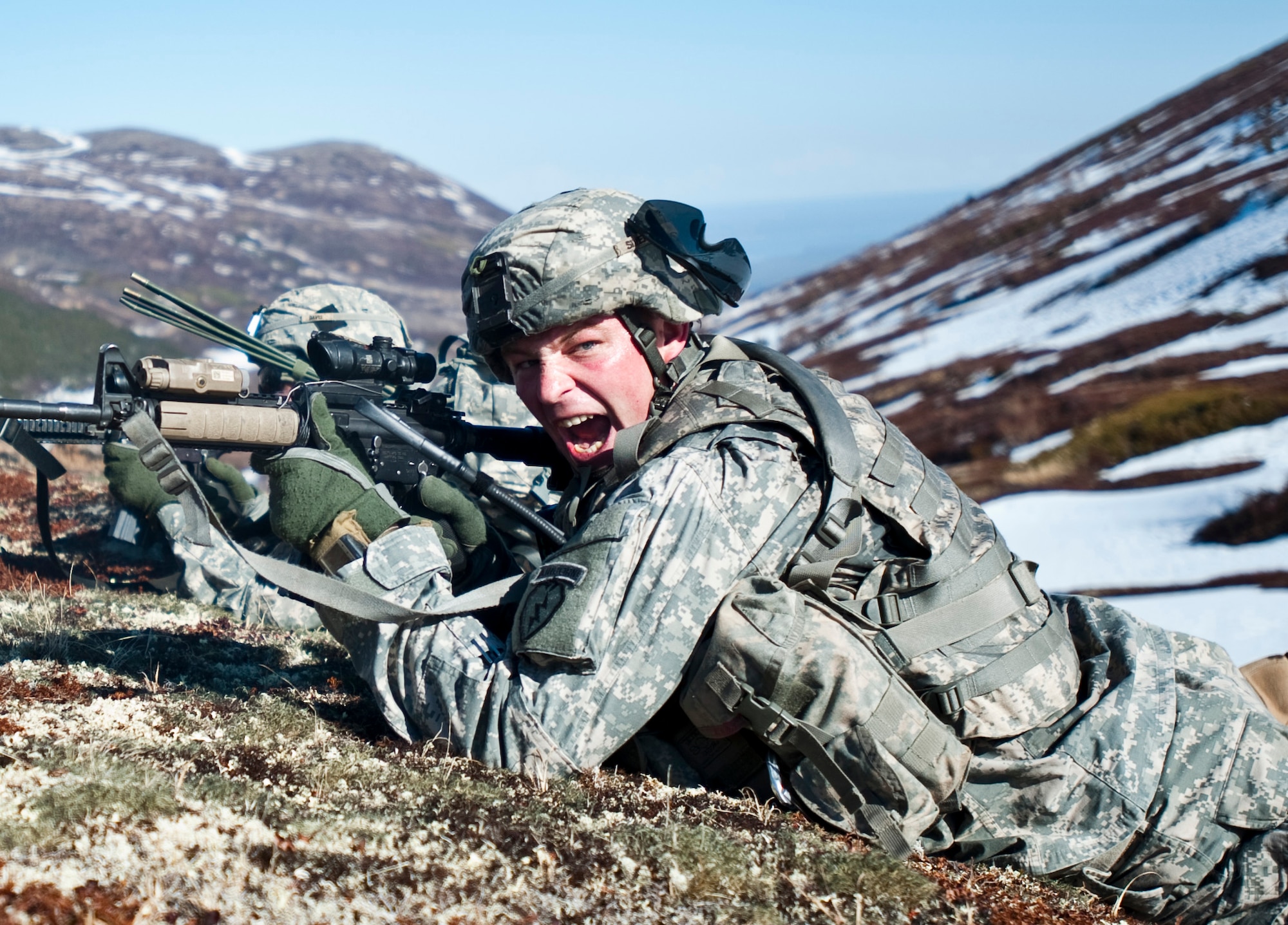 JOINT BASE ELMENDORF-RICHARDSON, Alaska -- Sgt. 1st Class Kyle Silvernale, platoon sergeant of the Comanche Company, 1st Battalion, 501st Infantry Regiment (Airborne), yells out commands to his troops while on an air assault training mission May 12. The Soldiers took part in the air assault training where UH-60 Black Hawk helicopters took them into a section of Alaska's Chugach Range and they were tasked with engaging an opposing force. (U.S. Air Force photo/Senior Airman Christopher Gross)