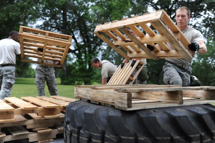 Airman 1st Class Joseph Schlank practices building up a pallet during the preparation for the confidence course at the Rodeo competition, where the 437th Aerial Port Squadron Rodeo team will be tested against numerous other base's teams over career field knowledge, endurance, speed, teamwork as well as safety at Joint Base Lewis-McChord, Wash. (U.S. Air Force photo/Staff Sgt. Katie Gieratz)(RELEASED)
