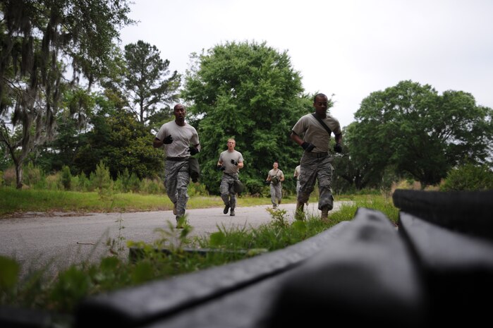 The 437th Aerial Port Rodeo team approach dunnage in Hunley Park May. 17 to carry during their preparation for the confidence course at the upcoming Rodeo competition at Joint Base Lewis-McChord. During the competition they will be tested against numerous other bases over career field knowledge, endurance, speed, teamwork as well as safety (U.S. Air Force photo/Staff Sgt. Katie Gieratz)(RELEASED)