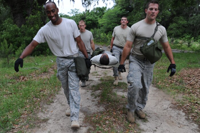 The 437th Aerial Port Rodeo team perform a litter carry in Hunley Park May. 17 during the team's preparation for the confidence course at the upcoming Rodeo competition at Joint Base Lewis-McChord. During the competition they will be tested against numerous other bases over career field knowledge, endurance, speed, teamwork as well as safety. (U.S. Air Force photo/Staff Sgt. Katie Gieratz)(RELEASED)