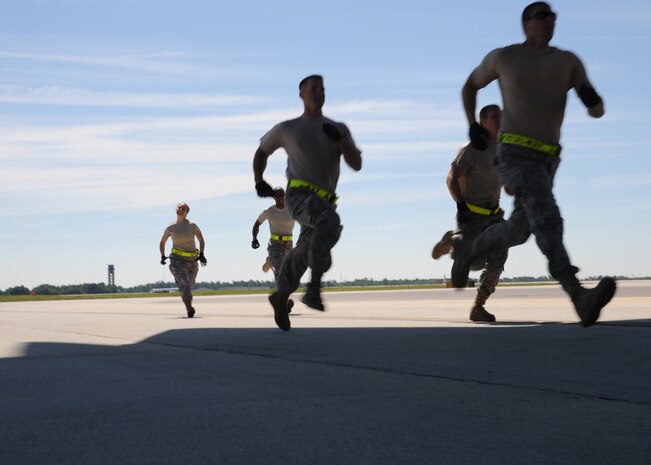 The 437th Aerial Port Rodeo team runs to a Charleston C-17 on the Joint Base Charleston flightline, May 18. in preparation for the engine running onload/offload at the Rodeo competition where they will be tested against numerous other bases over career field knowledge, endurance, speed, teamwork as well as safety at Joint Base Lewis-McChord, Wash.(U.S. Air Force photo/Staff Sgt. Katie Gieratz)(RELEASED)
