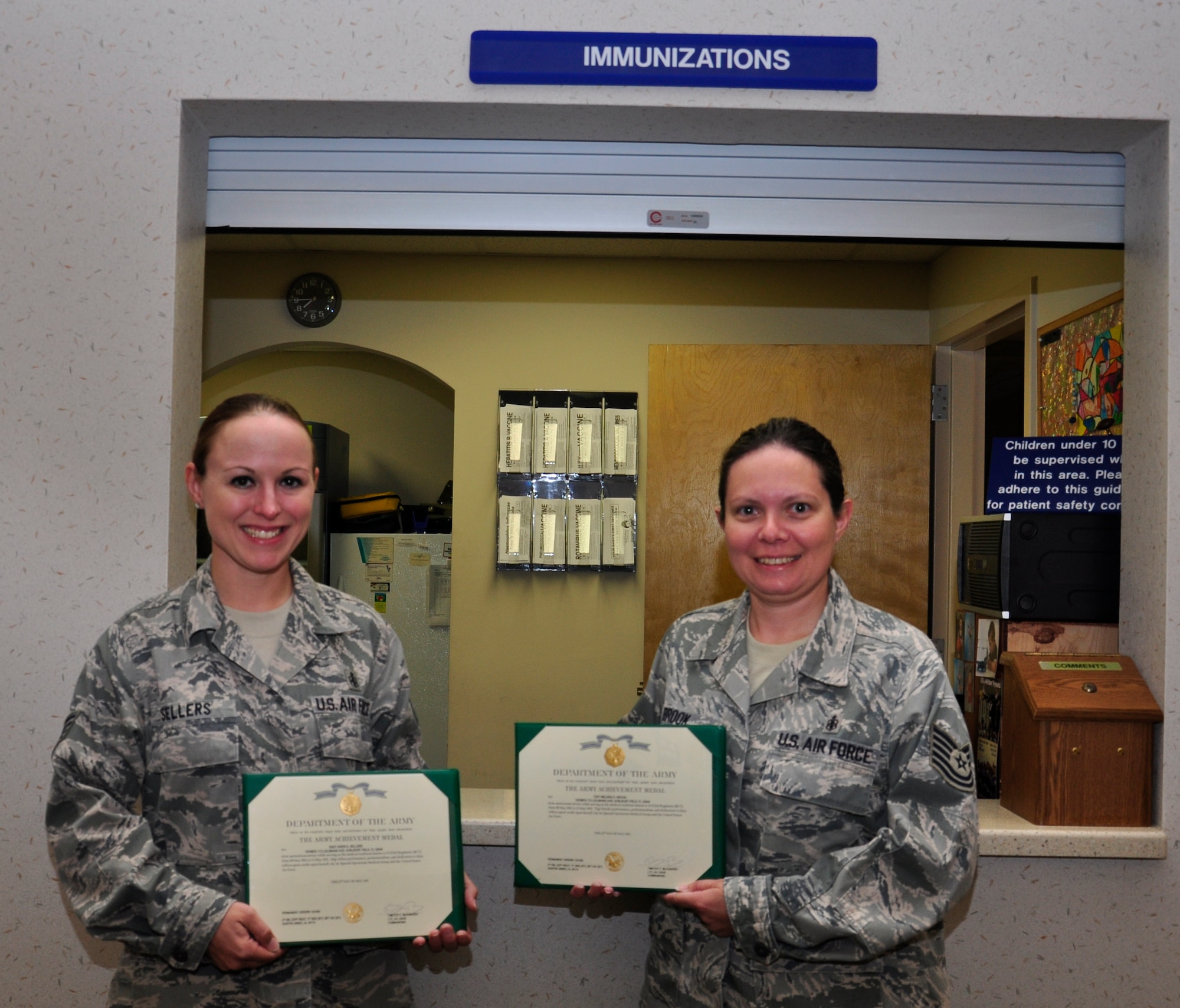 Staff Sgt. Sheri Sellers, 1st Special Operations Medical Operations Squadron immunization clinic NCO in charge, and Tech. Sgt. Melissa Brook, 1st SOMDOS immunization clinic technician, pose for a photograph with their Army Achievement Medals presented to them May 13, 2011, Hurlburt Field, Fla. The two sergeants were given the medal for the help they provided in ensuring the members of the Army Reserve 323rd Regiment, 4th Battalion stay medically ready for possible deployments. (Air Force photo by Staff Sgt. Sarah Martinez/RELEASED)