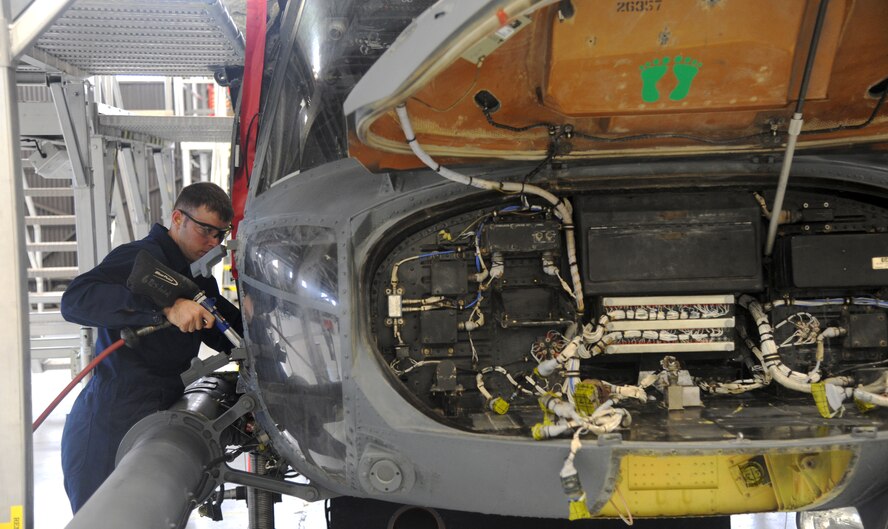 Tech. Sgt. Greg Barney, 23rd Equipment Maintenance Squadron phase coordinator, vacuums an HH-60G Pave Hawk May 17 at Moody Air Force Base, Ga. Sergeant Barney vacuumed the sand-filled helicopter after its return from a tour in Afghanistan. (U.S. Air Force photo/Airman 1st Class Paul Francis)(RELEASED) 
