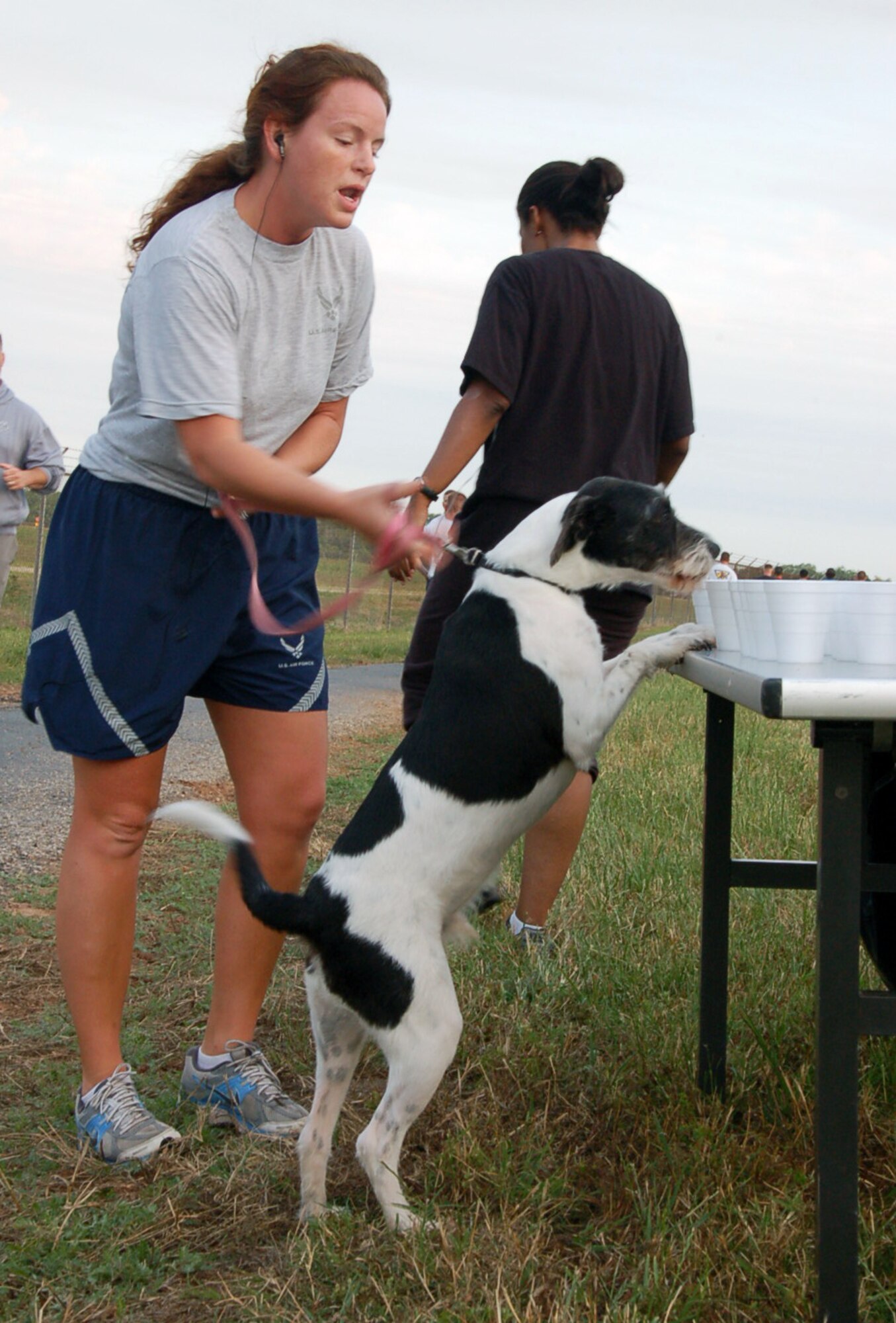 BARKSDALE AIR FORCE BASE, La. – Staff Sgt. Jessica Charlton, 608th Air Communications Squadron, and her dog, Vinny, stop to get water halfway through the Eighth Air Force 5K Fun Run May 18. The Mighty Eighth held the run in conjunction with the upcoming Eighth Air Force change of command. (U.S. Air Force photo by Staff Sgt. Brian Stives)
