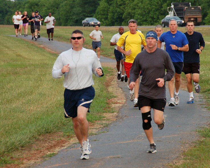 BARKSDALE AIR FORCE BASE, La. – Chief Master Sgt. Patrick McMahon (left), Eighth Air Force interim command chief master sergeant, and Master Sgt. Gary Leist, Eighth Air Force Security Forces, run ahead of Maj. Gen. Floyd Carpenter (blue shirt), Eighth Air Force commander, and Col. Robert Gass (yellow shirt), Eighth Air Force vice commander, one third of the way through the Eighth Air Force 5K Fun Run May 18. The Mighty Eighth held the run in conjunction with the upcoming Eighth Air Force change of command. (U.S. Air Force photo by Staff Sgt. Brian Stives)