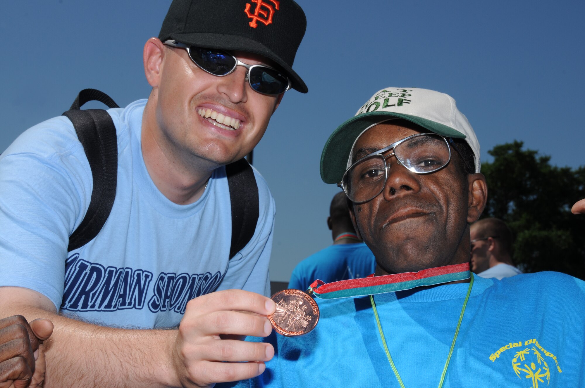 Airman 1st Class Matt Lubisich, 336th Training Squadron student, shows off the bronze medal won by his athlete, Anthony Brown, in the 50-meter run during Special Olympics, hosted by Keesler Friday and Saturday.  (U.S. Air Force photo by Kemberly Groue)