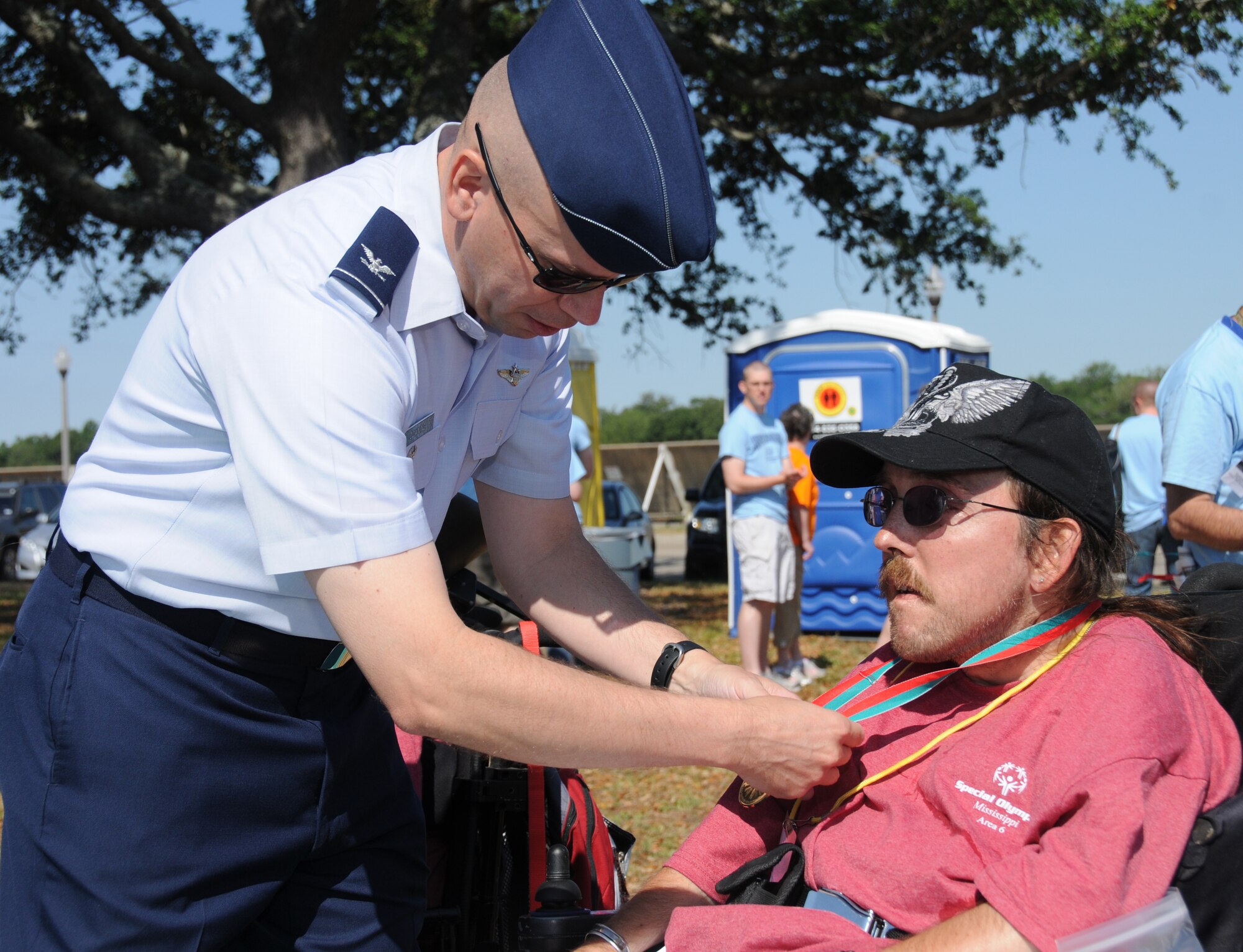 Col. Glen Downing, 81st Training Wing vice commander, awards athlete Mark Jones a gold medal for the 30-meter slalom event at Special Olympics, hosted by Keesler Friday and Saturday.  (U.S. Air Force photo by Kemberly Groue)