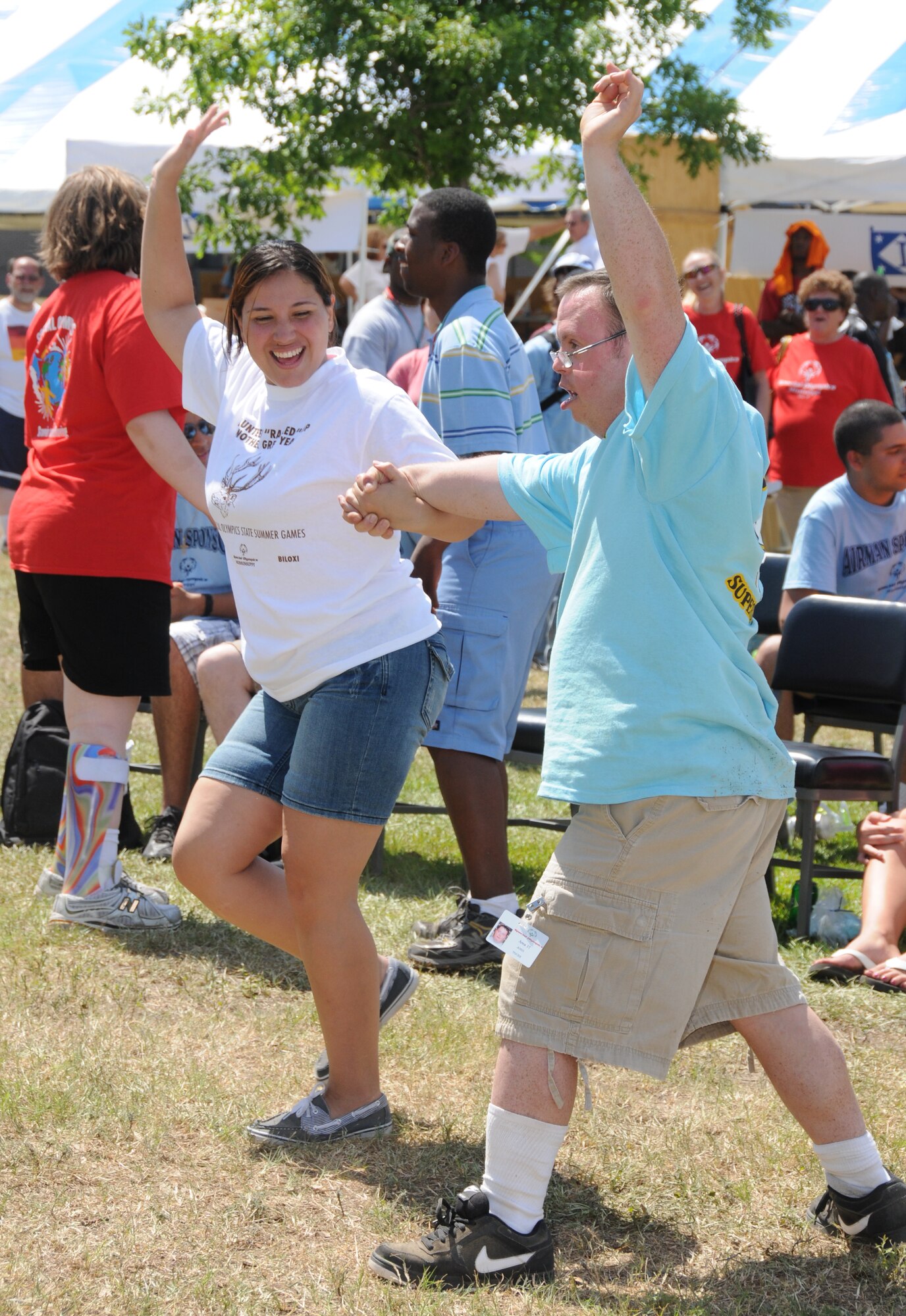 Vanessa Vanossenbruggen, left, 81st Force Support Squadron, dances with athlete John Toche as other athletes sing karaoke at the Olympic Village Saturday.  Volunteers from across the base planned for months and provided support for all aspects of the games.  (U.S. Air Force photo by Kemberly Groue)