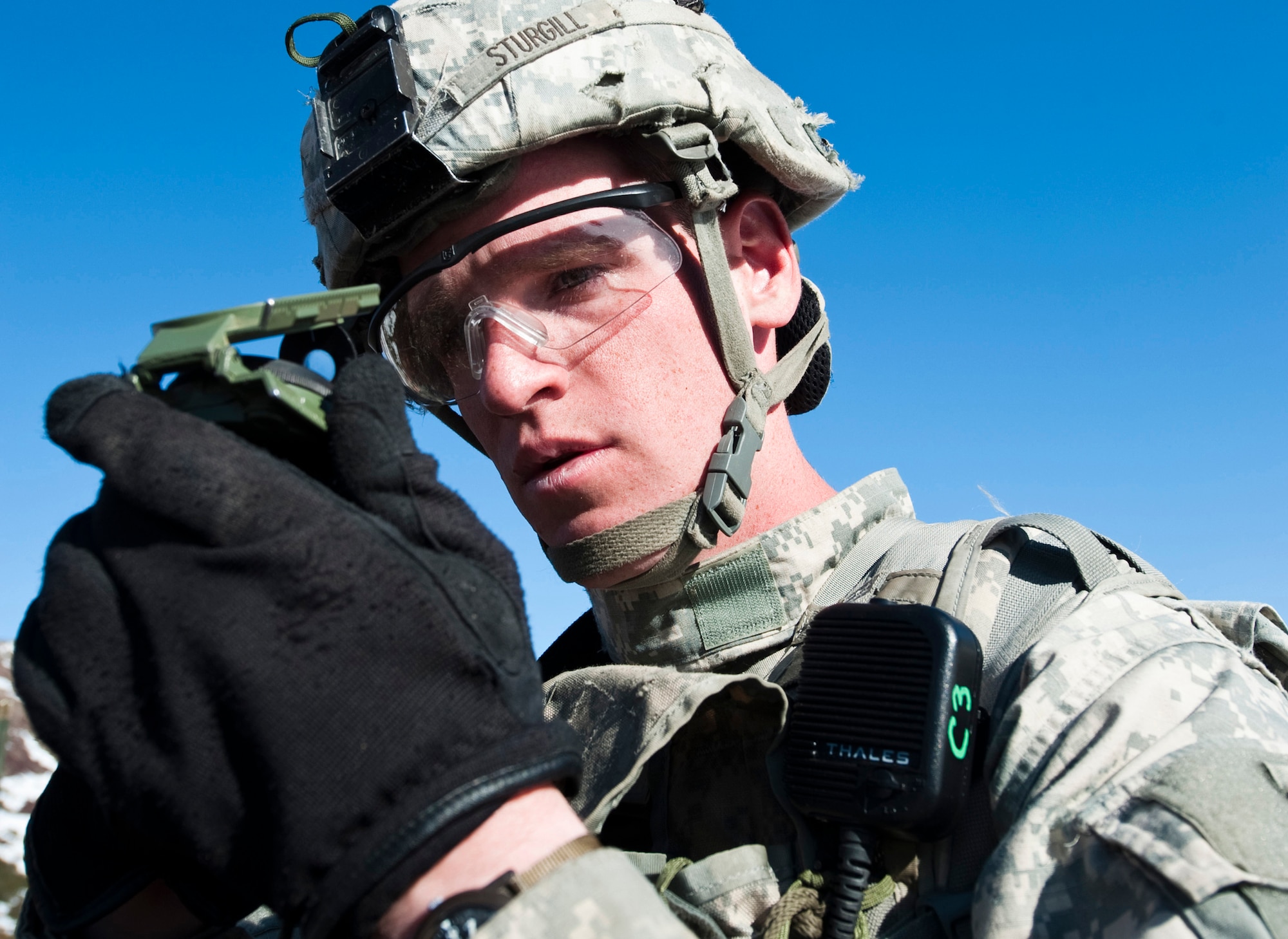 JOINT BASE ELMENDORF-RICHARDSON, Alaska -- Sgt. Kevin Sturgill of the Comanche Company, 1st Battalion, 501st Infantry Regiment (Airborne), checks his compass while on patrol through Alaska's Chugach Range May 12. Soldiers took part in air assault training where UH-60 Black Hawks helicopters took them into a section of the mountain range and they were tasked with engaging an opposing force.  (U.S. Air Force photo/Senior Airman Christopher Gross)