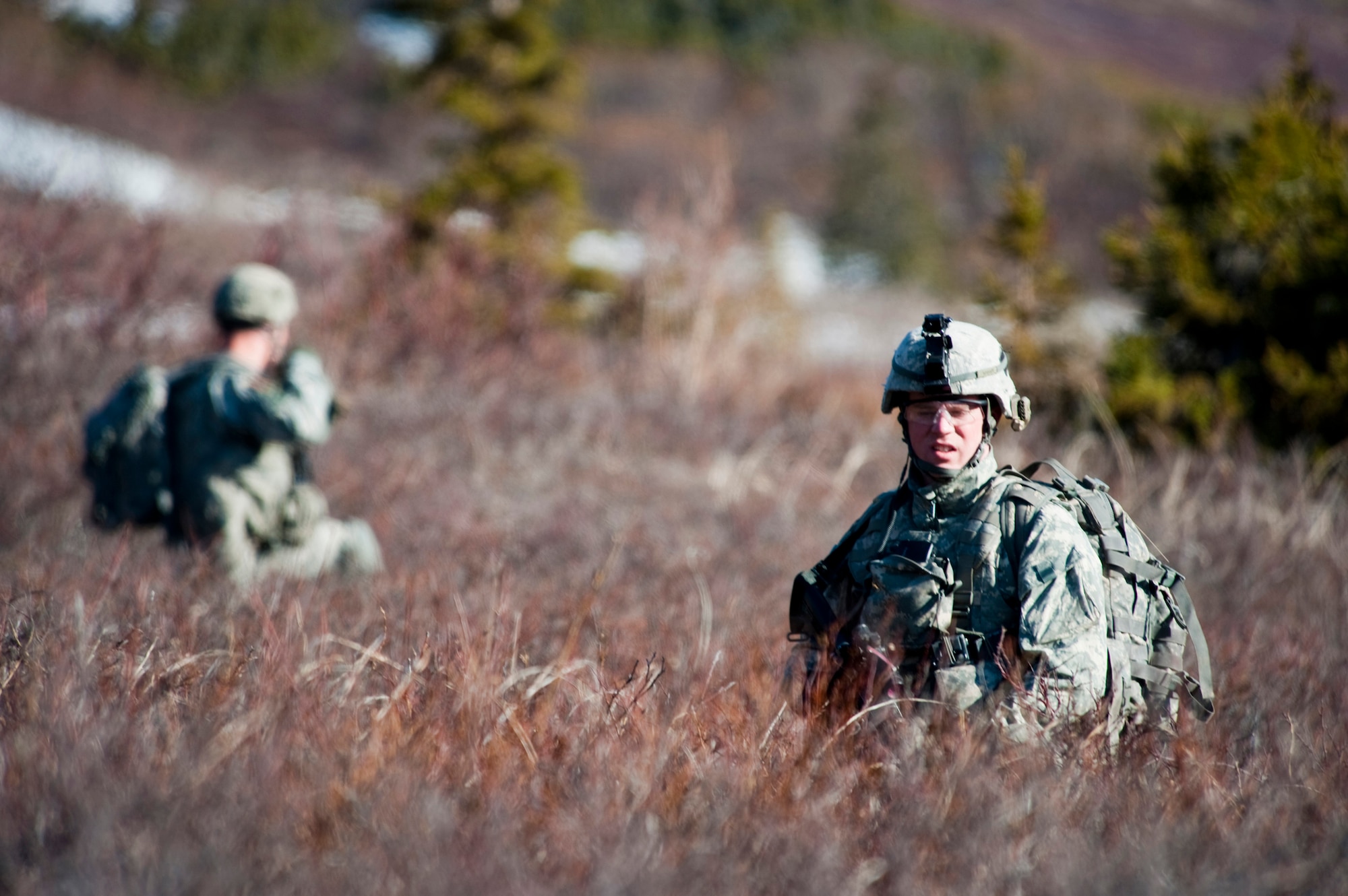 JOINT BASE ELMENDORF-RICHARDSON, Alaska -- Sgt. Jesse Whinnem of the Comanche Company, 1st Battalion, 501st Infantry Regiment (Airborne), patrols through Alaska's Chugach Range May 12. Soldiers took part in air assault training where UH-60 Black Hawk helicopters took them into a section of the mountain range and they were tasked with engaging an opposing force.  (U.S. Air Force photo/Senior Airman Christopher Gross)