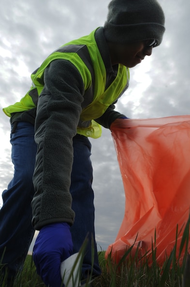 MINOT, N.D. -- Senior Airman Fernando Andres-Miguel, 5th Communication Squadron knowledge operations manager, picks up trash along the Highway 83 bypass May 14. He is a member of the Air Force Sergeant’s Association, who has adopted the designated section of the highway to keep clean regularly. This is all part of an effort by the AFSA to help keep the Minot community beautiful and free of litter. (U.S. Air Force photo/Airman 1st Class Aaron-Forrest Wainwright)