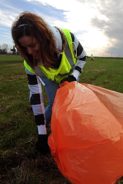 MINOT, N.D. -- Senior Airman Jessica Mendez, 5th Medical Group physical therapist, picks up trash along the Highway 83 bypass May 14. She is a member of the Air Force Sergeant’s Association, who has adopted the designated section of the highway to keep clean regularly. This is all part of an effort by the AFSA to help keep the Minot community beautiful and free of litter. (U.S. Air Force photo/Airman 1st Class Aaron-Forrest Wainwright)