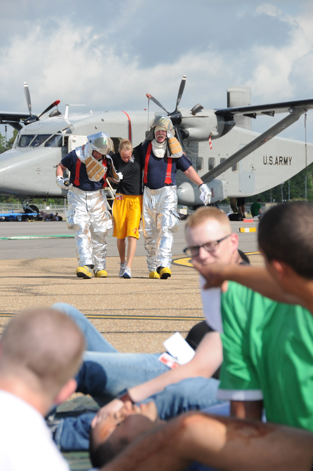 Firefighters from the Air National Guard Combat Readiness Training Center in
Gulfport escort Airman Basic Stacie Ahlers to a triage area to receive medical treatment for her “injuries” during a simulated aircraft crash exercise May 10. Airman Ahlers, 332nd Training Squadron, was one of 50 students from the 81st Training Group who participated in the Gulfport- Biloxi International Airport’s tri-annual full scale disaster drill. The drill, which tests the airport’s emergency plan, is part of its certification process and involves several federal, state and local agencies.  (U.S. Air Force photo by Kemberly Groue)