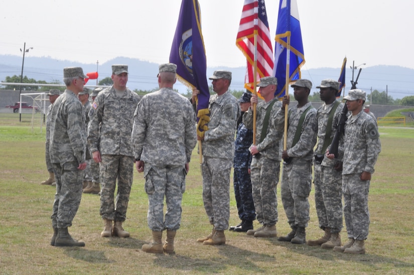 SOTO CANO AIR BASE, Honduras - Joint Task Force-Bravo Command Sergeant Major Karl J. Groninger presents the JTF-B flag so Gen. Douglas M. Fraser, U.S. Southern Command commander can pass command from Col. Gregory D. Reilly to Col. Ross A. Brown during a change of command ceremony here, May 18. (Department of Defense photo/Martin Chahin)