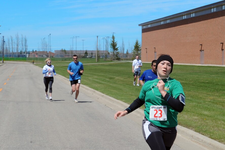MINOT AIR FORCE BASE, N.D. -- 2nd Lt. Elizabeth Allen, 5th Force Support Squadron manpower officer, finishes a 10K run as part of the Triple Crown event here May 14. The Triple Crown event is a three part cardio tournament consisting of a 5K, 10K, and triathlon run during the month of May. Events like there are designed to promote fitness among Airmen. (U.S. Air Force photo/Airman 1st Class Aaron-Forrest Wainwright)