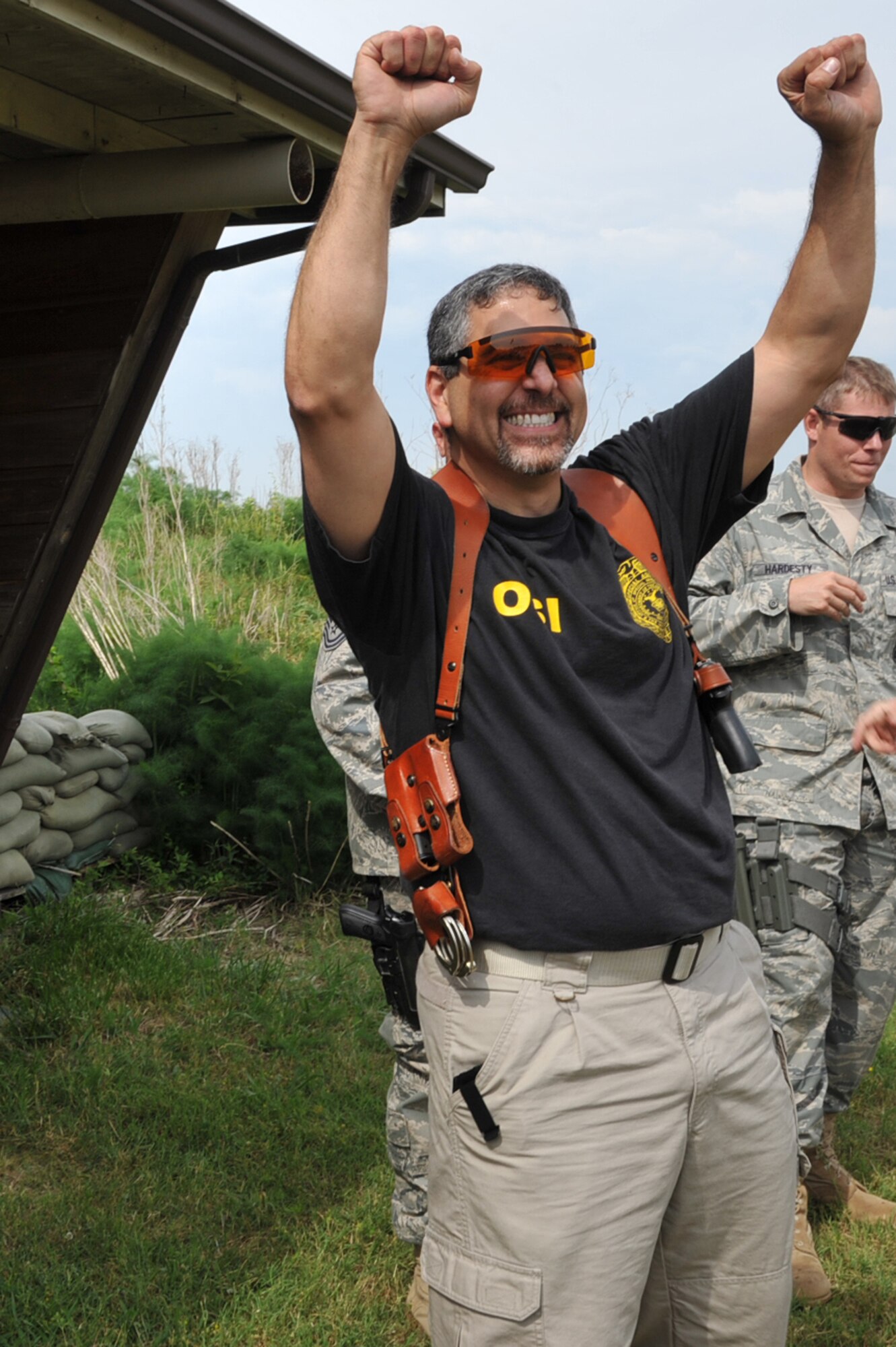 Michael Hassan, Air Force Office of Special Investigations, 2nd Field Investigations Region, celebrates his teams win during the 633d Security Forces shooting competition at Langley Air Force Base, Va., May 16, 2011. Participants from the Hampton police department, Hampton park rangers, security forces, Newport News police department and the Air Force Office of Special Investigations competed in the event held as part of National Police Week. (U.S. Air Force photo by Airman 1st Class Camilla Griffin)(RELEASED)