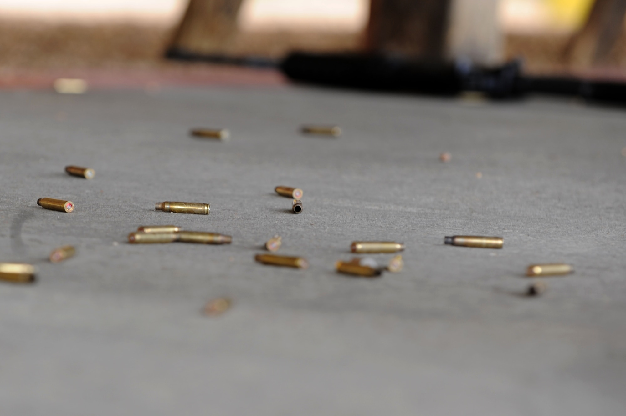 Empty bullet casings lay on the ground after a round of shooting during the 633d Security Forces shooting competition at Langley Air Force Base, Va., May 16, 2011. Participants from the Hampton police department, Hampton park rangers, security forces, Newport News police department and the Air Force Office of Special Investigations competed in the event. (U.S. Air Force photo by Airman 1st Class Racheal Watson)(RELEASED)