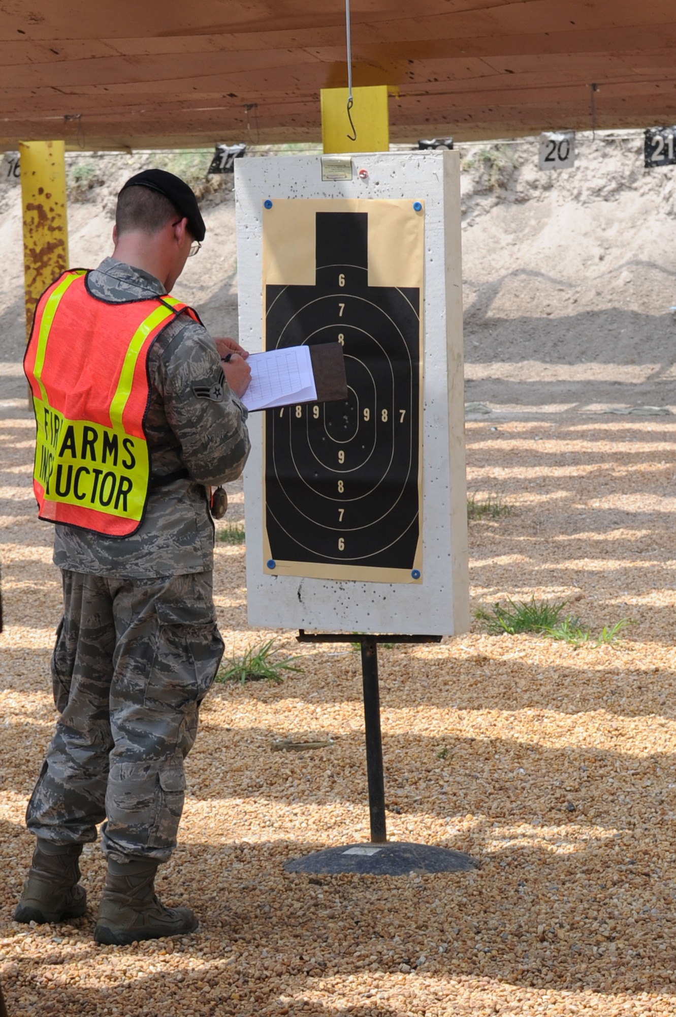 Airman 1st Class Ryan Vendrely, 633d Security Forces Squadron entry controller, records the score of a shooter during the 633d Security Forces shooting competition at Langley Air Force Base, Va., May 16, 2011. The event is part of National Police week, celebrating and honoring military and civilian defenders. (U.S. Air Force photo by Airman 1st Class Racheal Watson)(RELEASED)