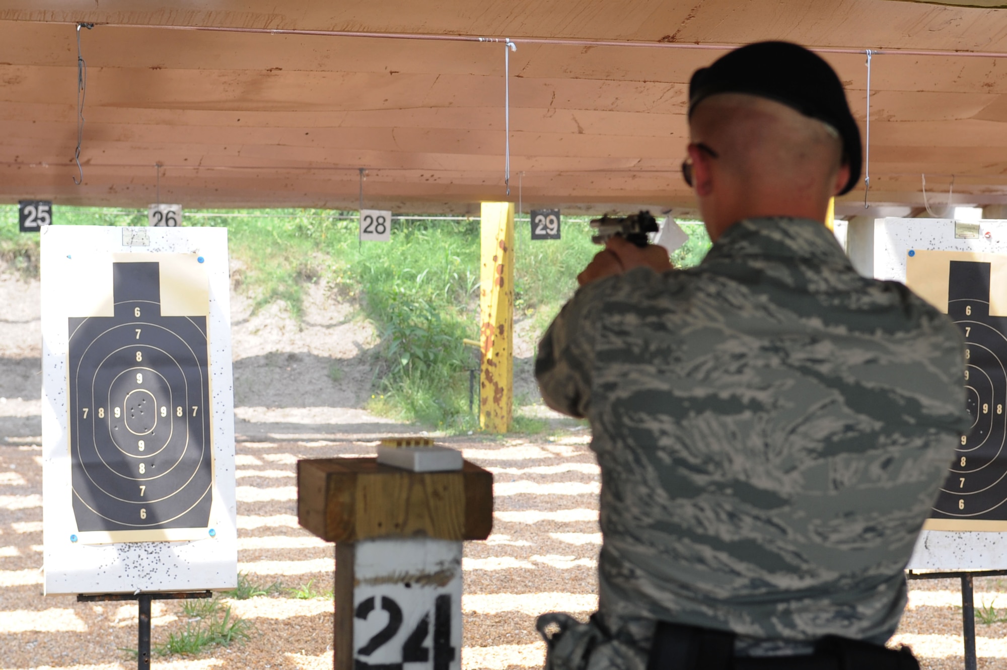 Airman 1st Class David Shreve, 633d Security Forces Squadron member, shoots at a target during the 633d Security Forces shooting competition during National Police Week at Langley Air Force Base, Va., May 16, 2011. National Police week is an annual event held to remember fallen defenders, both military and civilian. (U.S. Air Force photo by Airman 1st Class Racheal Watson)(RELEASED)