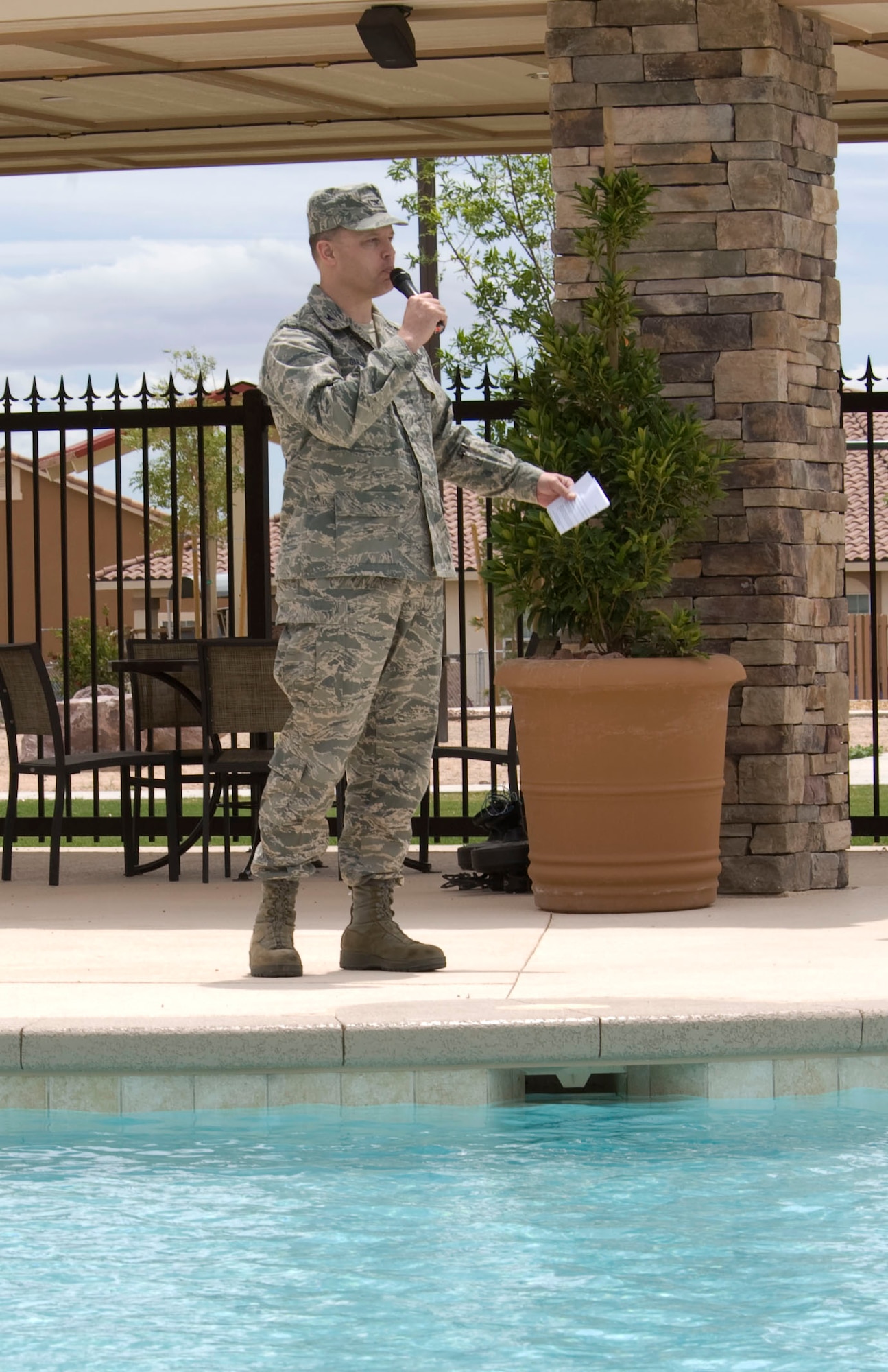 NELLIS AIR FORCE BASE, Nev.-- Col. Steven Garland, 99th Air Base Wing commander, speaks during the recreational pool completion ceremony May 17.  The pool area, which is more than 4,700 square feet and can hold up to 450 people, was designed for base residents and their families and will open June 4. Construction began in 2009 with the assistance of Hunt Military Communities.  (U.S Air Force photo by Senior Airman Stephanie Rubi)