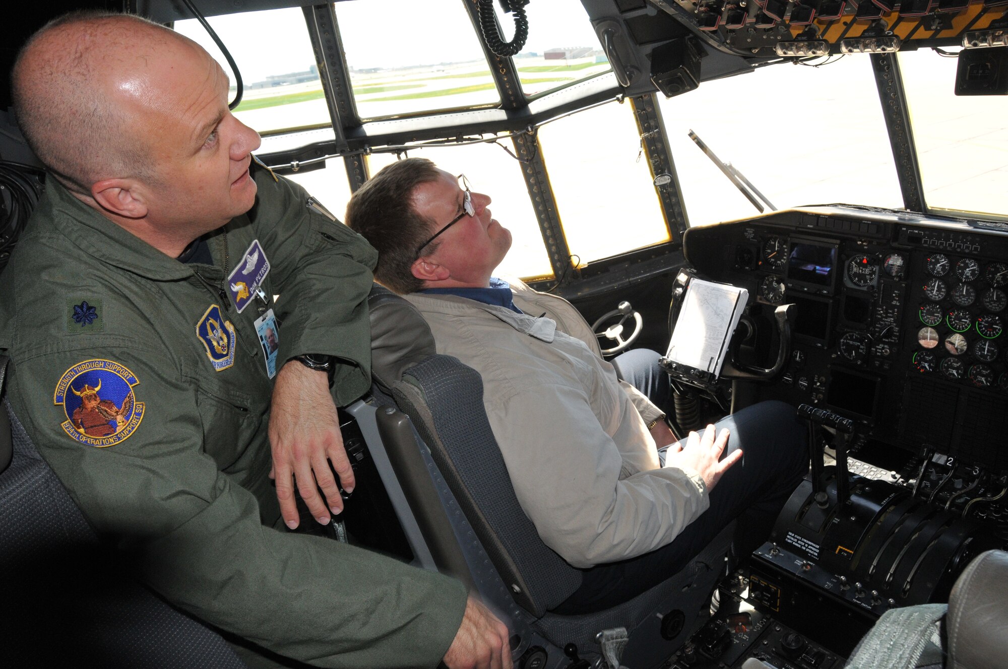 Lt. Col. Don Petros, 934th Operations Support Squadron, shows David Downing, 934th Operations Group Honorary Commander, the cockpit of a C-130 during the Honorary Commanders Tour May 15. (Air Force Photo/Master Sgt. Paul Zadach)