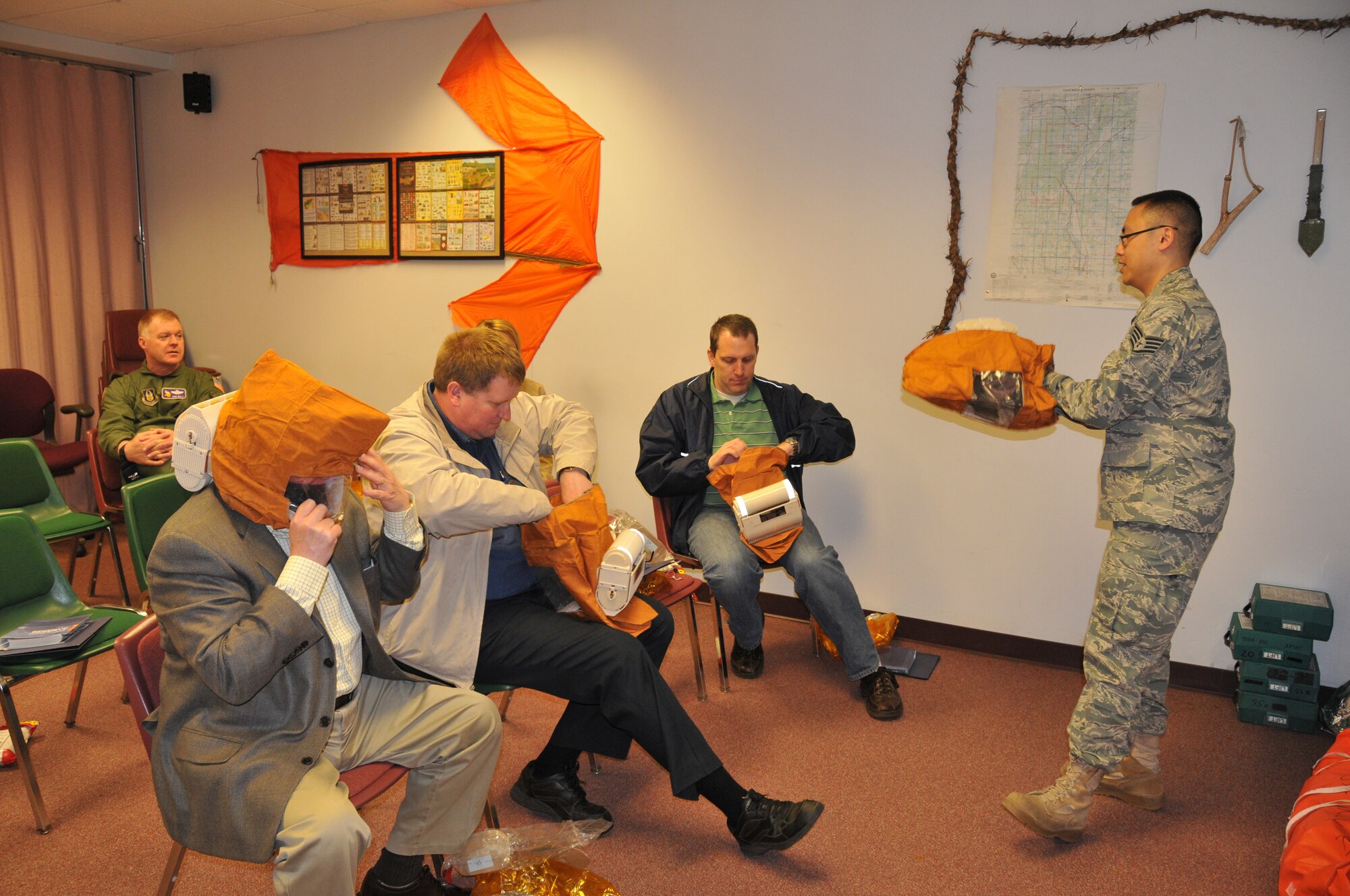 Staff Sgt. Laishun Mak, 934th Aircrew Flight Equipment, demonstrates emergency oxygen masks during the Honorary Commanders Tour May 15. (Air Force Photo/Master Sgt. Paul Zadach)
