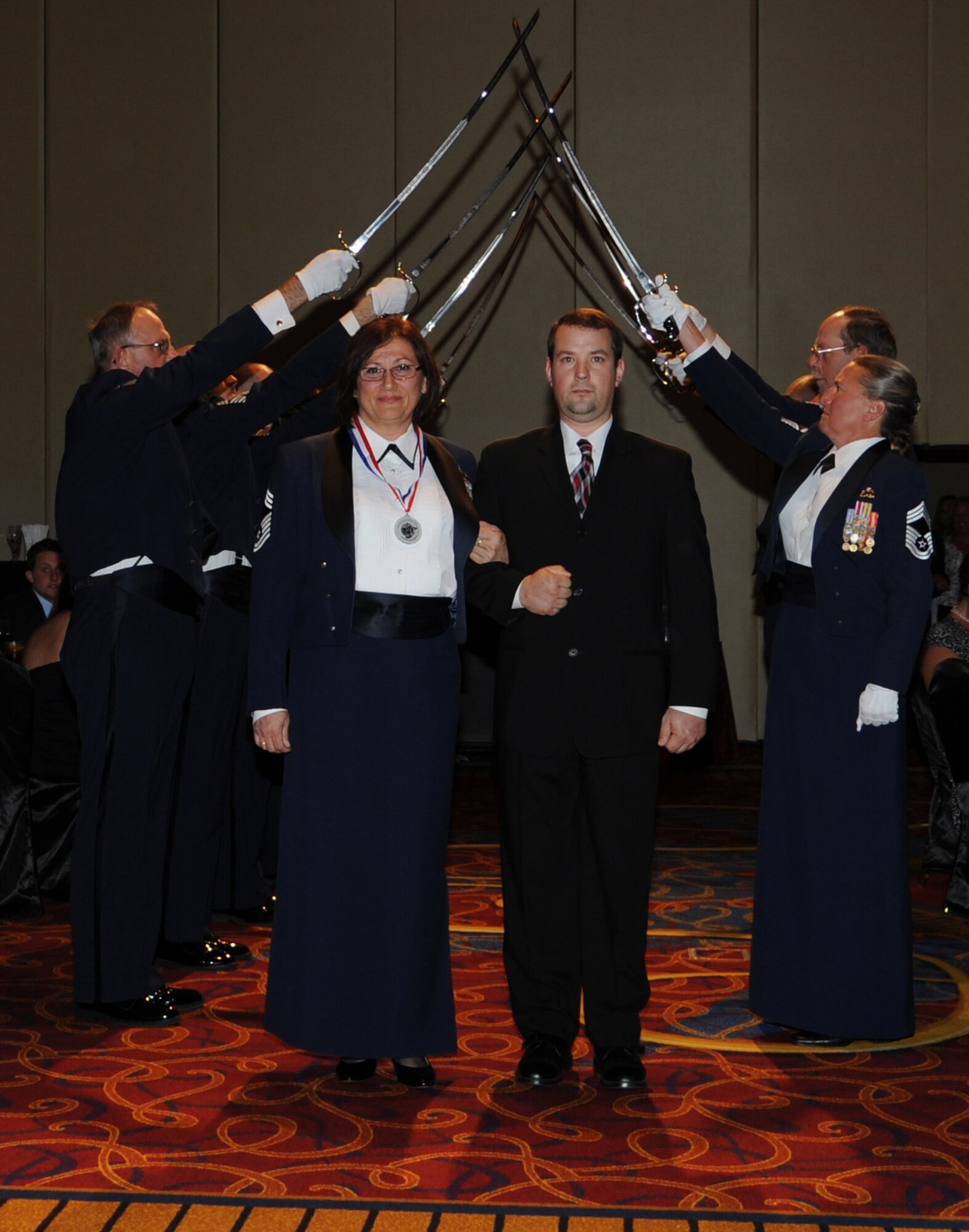 JOINT BASE MCGUIRE-DIX-LAKEHURST, N.J. -  Chief Master Sgt. Danica Dejanovic and husband, Ryan Trebisovsky, enter the Grand Cayman Ballroom May 14 at the Trump Marina Hotel in Atlantic City, N.J., for the Chief Induction Ceremony. Fifteen active duty, Guard and Reserve Airmen were inducted into the highest enlisted rank during the formal event. (U.S. Air Force photo/Airman 1st Class Dennis Sloan)  