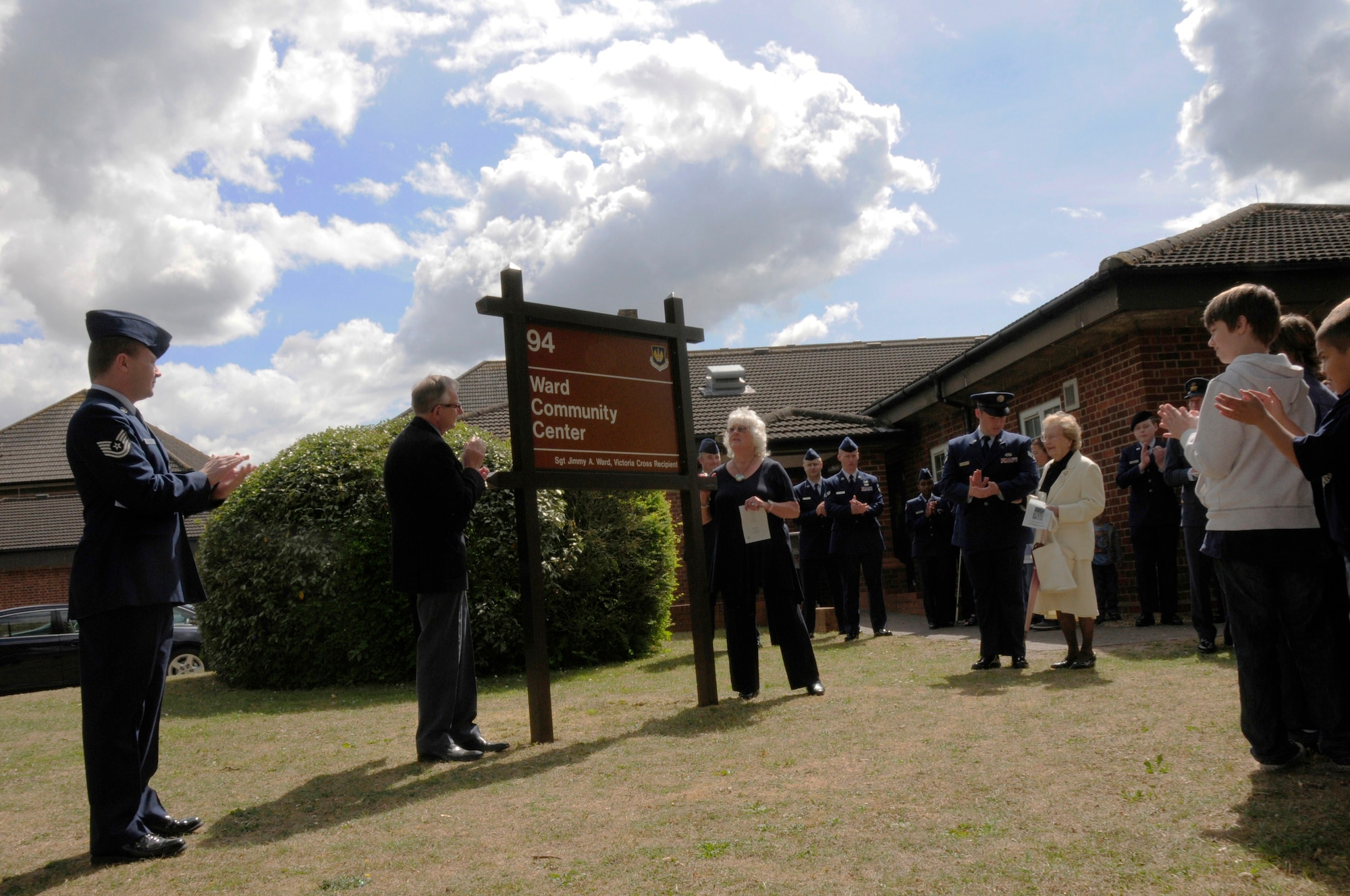 ROYAL AIR FORCE FELTWELL, England -- Members from the Friends of the No. 75 New Zealand Squadron Association, help unveil the new Ward Community Activity Center sign during the building dedication ceremony on May 14, 2011. The building was named in honor of Sgt. James A. Ward, the first New Zealander awarded the Victoria Cross; the British equivalent of the Medal of Honor. Sergeant Ward was stationed at RAF Feltwell with the Royal New Zealand Air Force No. 75 Squadron during World War II. He was awarded the medal for his heroic actions on July 7, 1941, when his Wellington bomber caught fire from an enemy attack. (U.S. Air Force photo/Staff Sgt. Connor Estes)