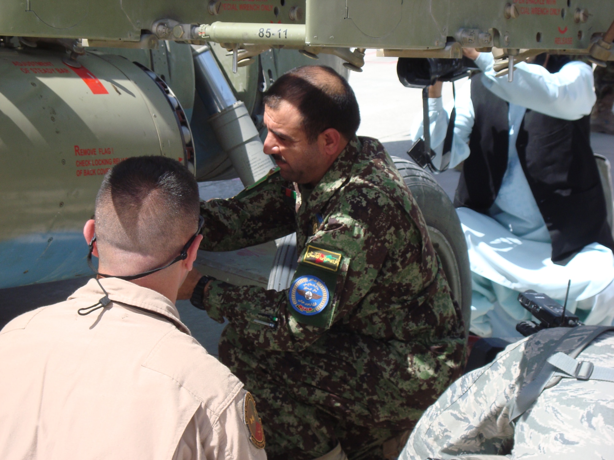 Afghan air force Maj. Gen. Sherzai loads a rocket at the first AAF arming point May 15, 2011,  Kandahar Airfield, Afghanistan. Kandahar Air Wing officials opened the first Afghan Mi-17 weapons arming point May 15. (U.S. Air Force courtesy photo) 