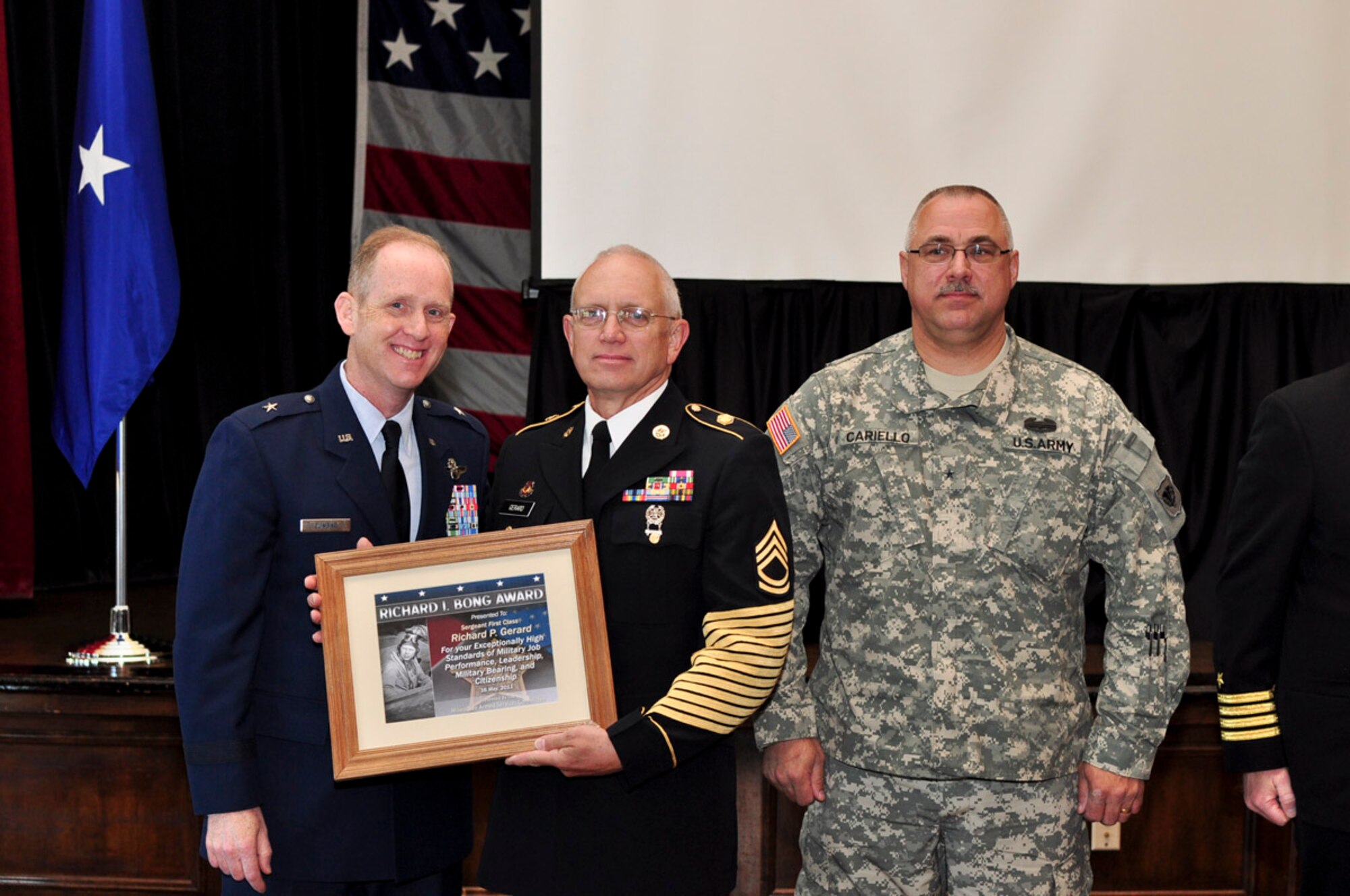 Sergeant First Class Richard P. Gerard of the 132nd Army Band receives the Bong Award during the ESGR breakfast held at the Wisconsin Club in downtown Milwaukee, May 16, 2011. Each year the Milwaukee Armed Forces Committee and Wisconsin Committee for Employer Support of the Guard and Reserve (ESGR) recognize the men and women who serve the armed forces and the employers that support them. U.S. Air Force photo by Tech Sgt. Thomas J Sobczyk / Released