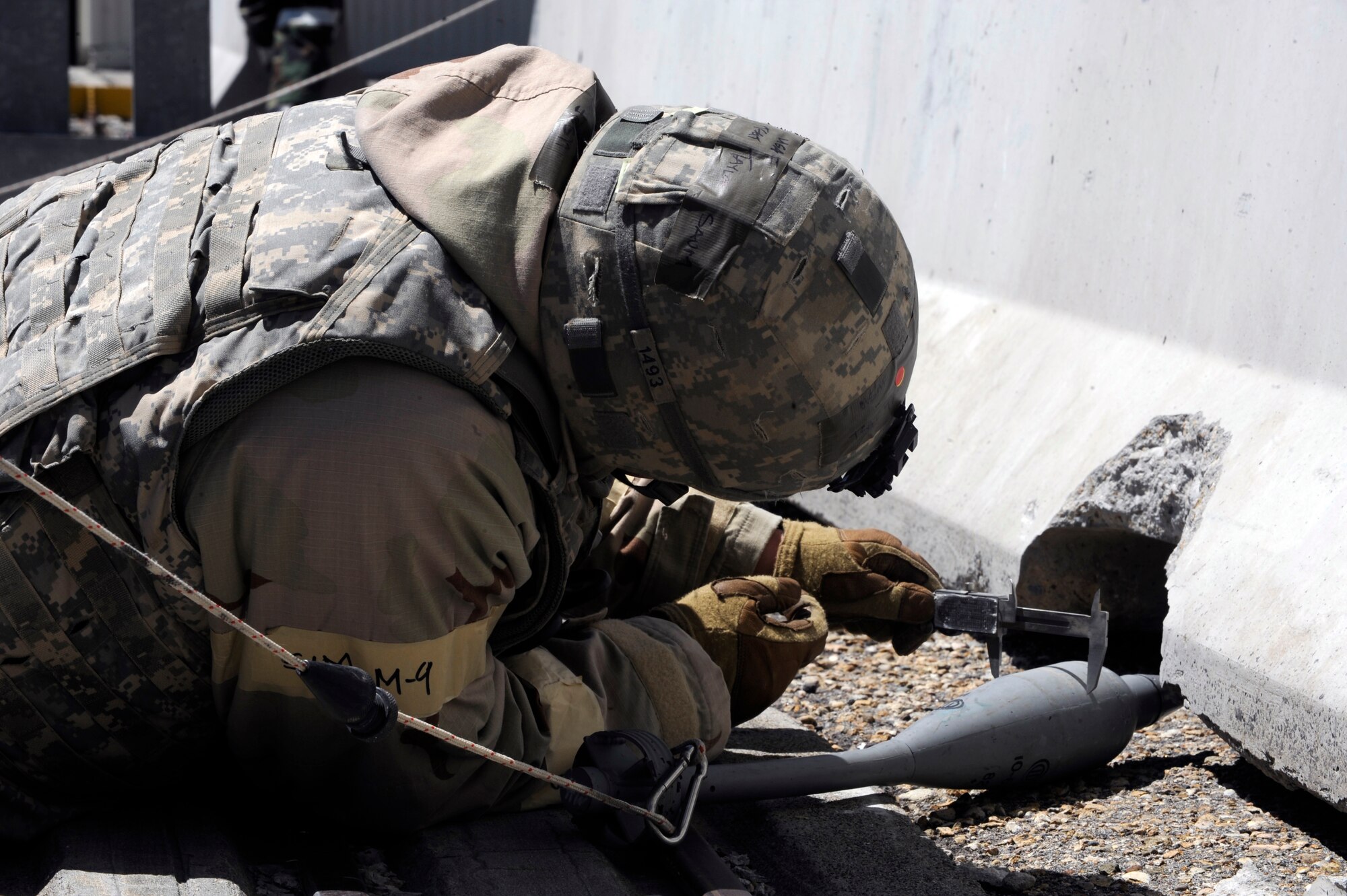 MOUNTAIN HOME AIR FORCE BASE, Idaho – Tech Sgt Taylor Saum, 366th Civil Engineer Squadron, responds to a simulated Explosive Ordinance call outside hangar 1333. Sergeant Saum measures the width of the ordinance during the Phase II Operational Readiness Exercise May 11. (U.S. Air Force photo by Senior Airman Angelina Drake)