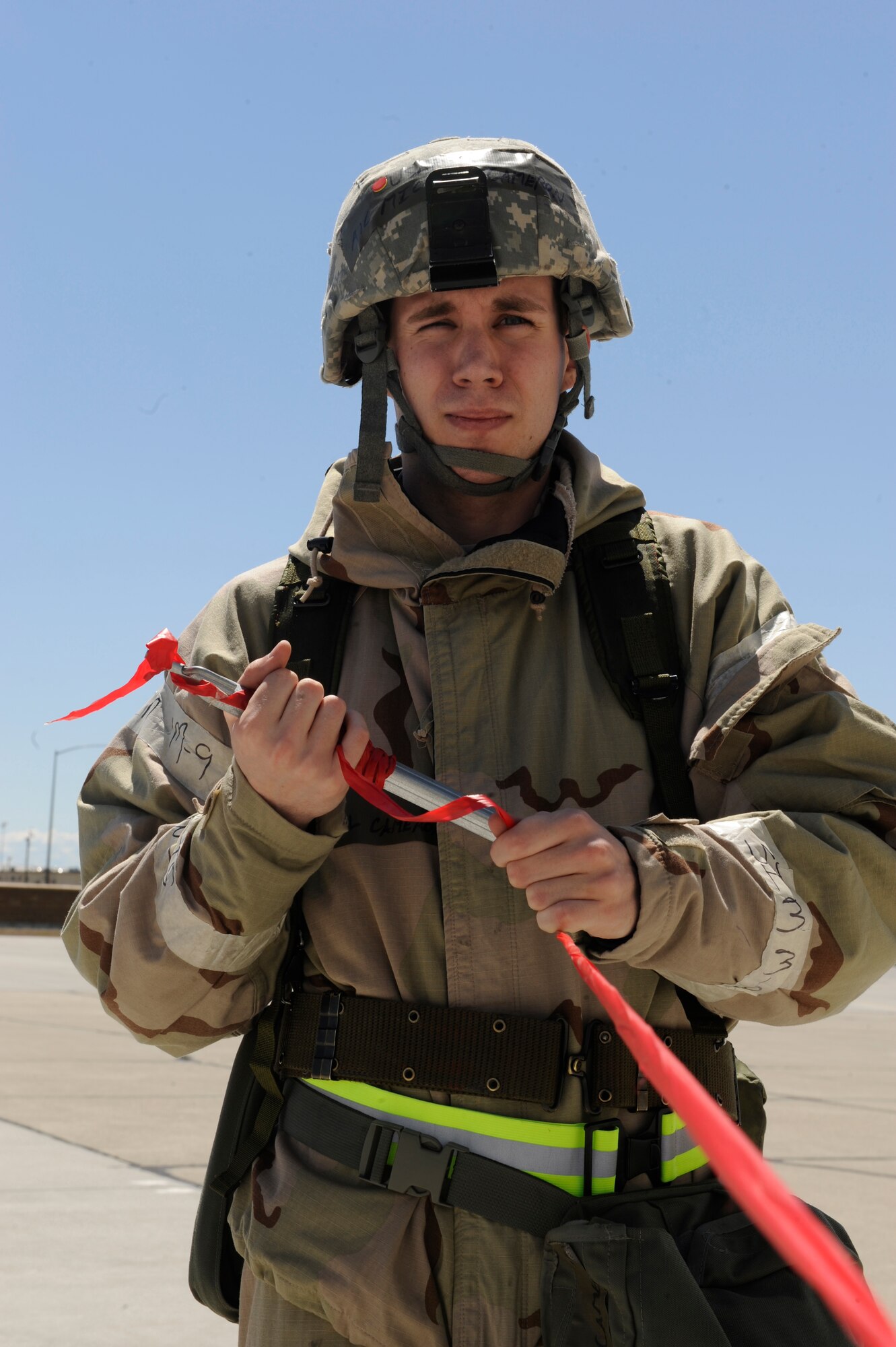MOUNTAIN HOME AIR FORCE BASE, Idaho – Airman 1st Class Michael Cameron, 366th Logistics Readiness Squadron, assists in building a cordon around a simulated Unexploded Ordinance. Airman Cameron was a member of one of the two Post Attack Reconnaissance (PAR) teams outside hangar 1333 that discovered the UXO during the Phase II Operational Readiness Exercise May 11. (U.S. Air Force photo by Senior Airman Angelina Drake)