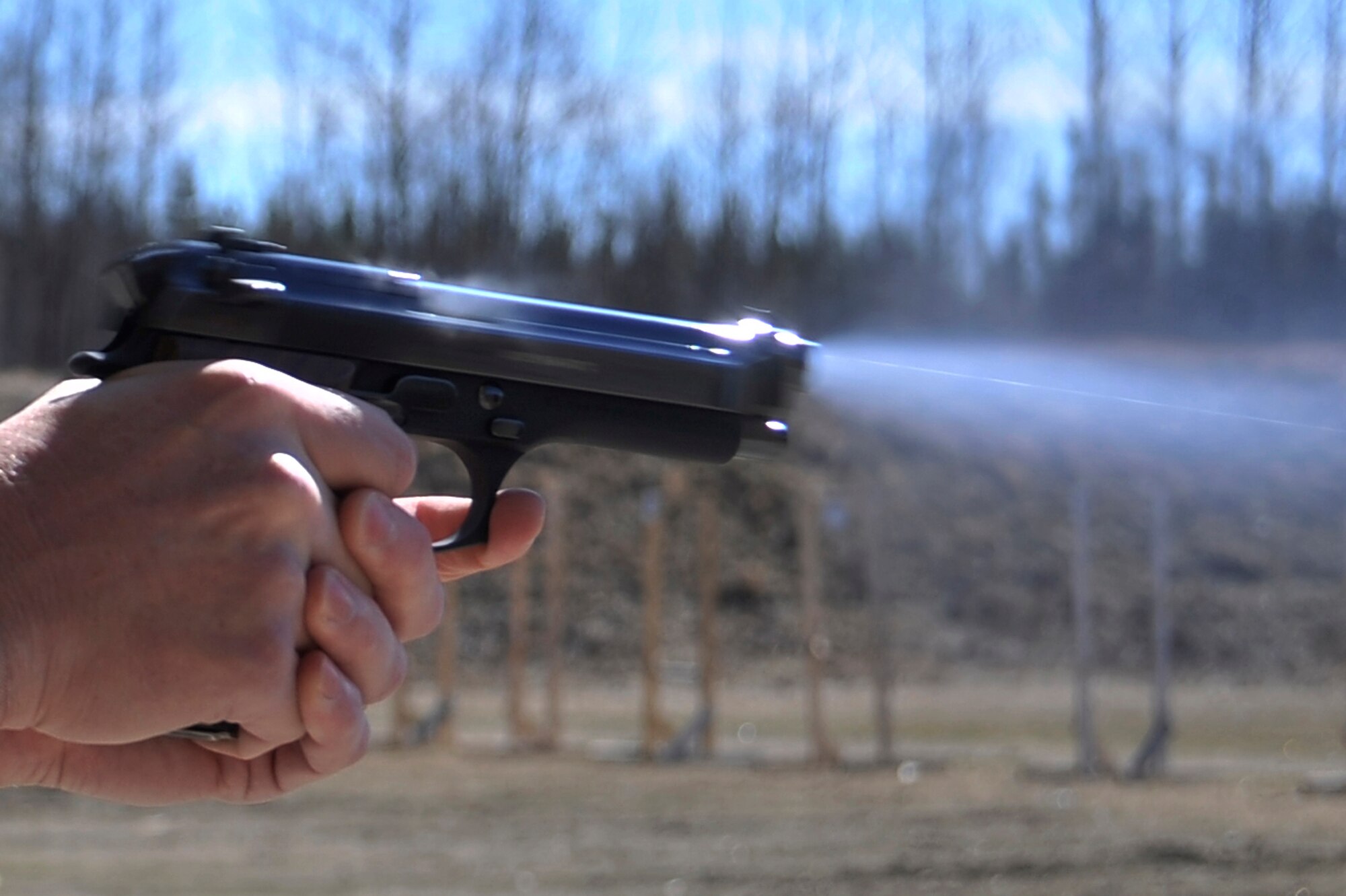 An M9 Pistol is fired during a pistol shoot at the combat arms firing range May 16, 2011, Eielson Air Force Base, Alaska. The event kicked off National Police Week which honors members of the law enforcement community. (U.S. Air Force photo/Staff Sgt. Christopher Boitz)