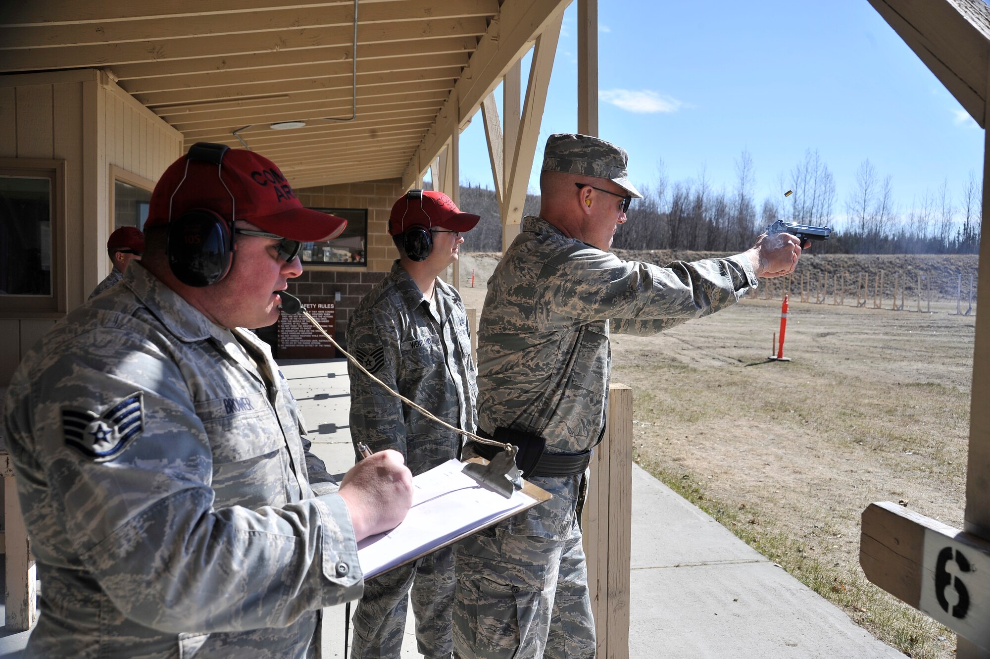 Brig. Gen. James N. Post III competes in a timed firing competition during a  pistol shoot at the combat arms firing range May 16, 2011, Eielson Air Force Base, Alaska. The event kicked off National Police Week, which honors members of the law enforcement community. General Post is the 354th Fighter Wing commander. (U.S. Air Force photo/Staff Sgt. Christopher Boitz)