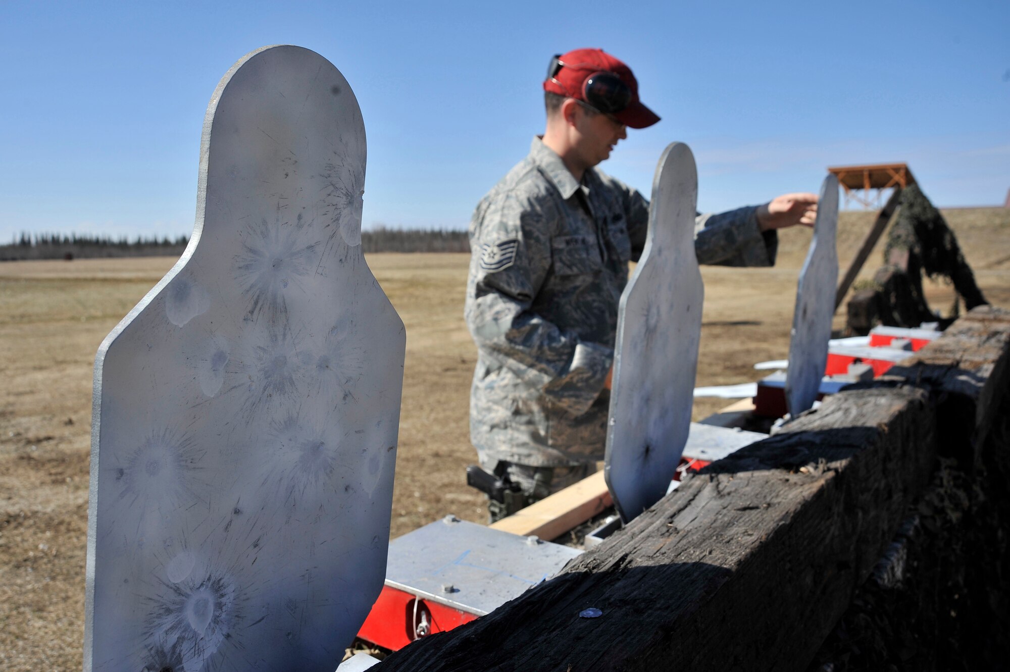Tech. Sgt. Michael Wentland sets up LaRue pop-up targets during a pistol shoot at the combat arms firing range May 16, 2011, Eielson Air Force Base, Alaska. The event kicked off National Police Week, which honors members of the law enforcement community. Sergeant Wentland is non-commissioned officer in charge of Combat Arms Training and Maintenance. (U.S. Air Force photo/Staff Sgt. Christopher Boitz)